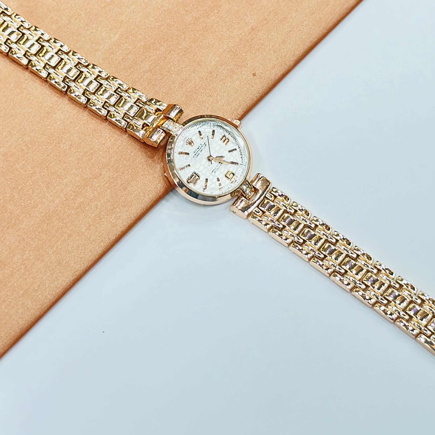 gold-tone ladies' watches with a sparkling bezel and metallic strap