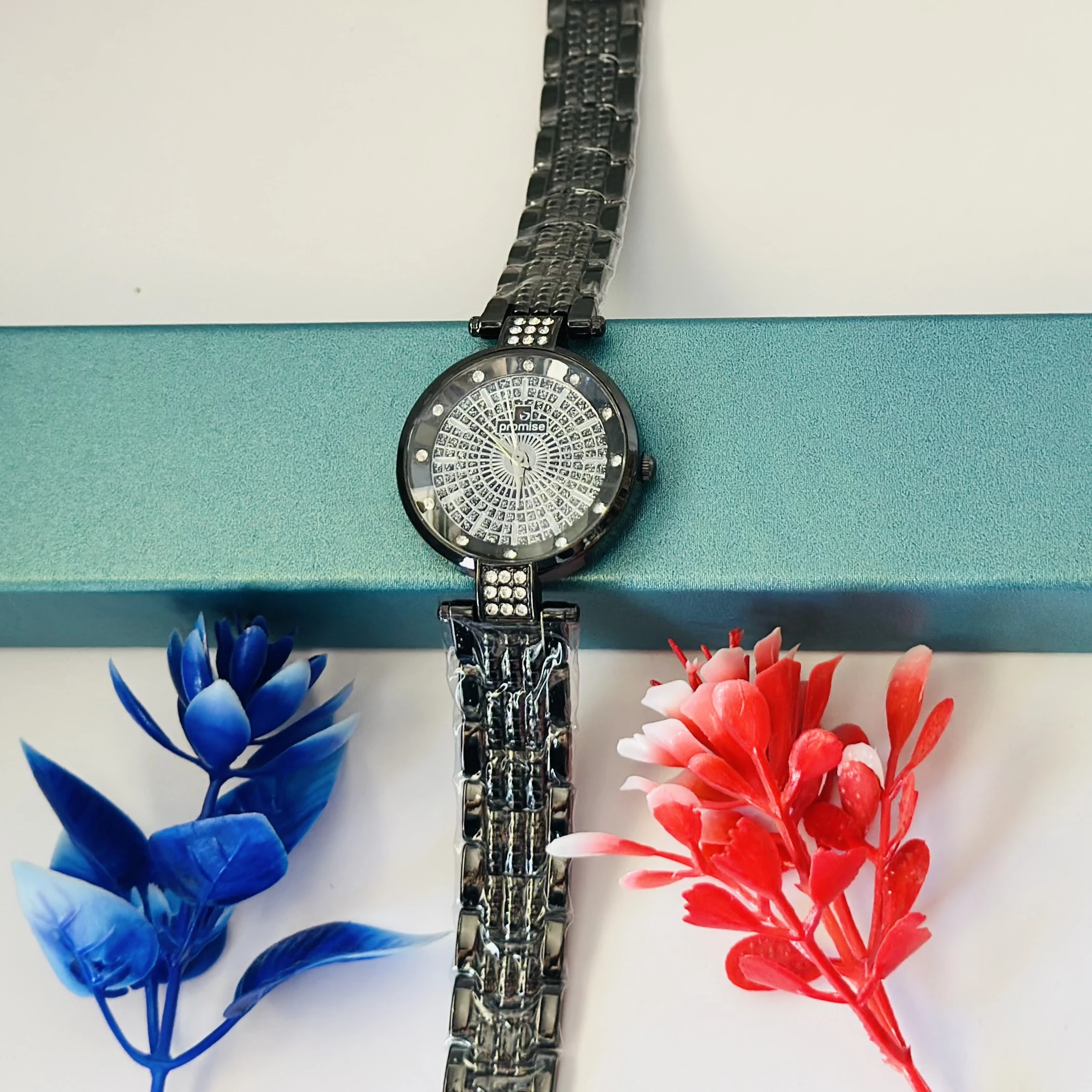 Ladies fashion watch with a black metal strap.