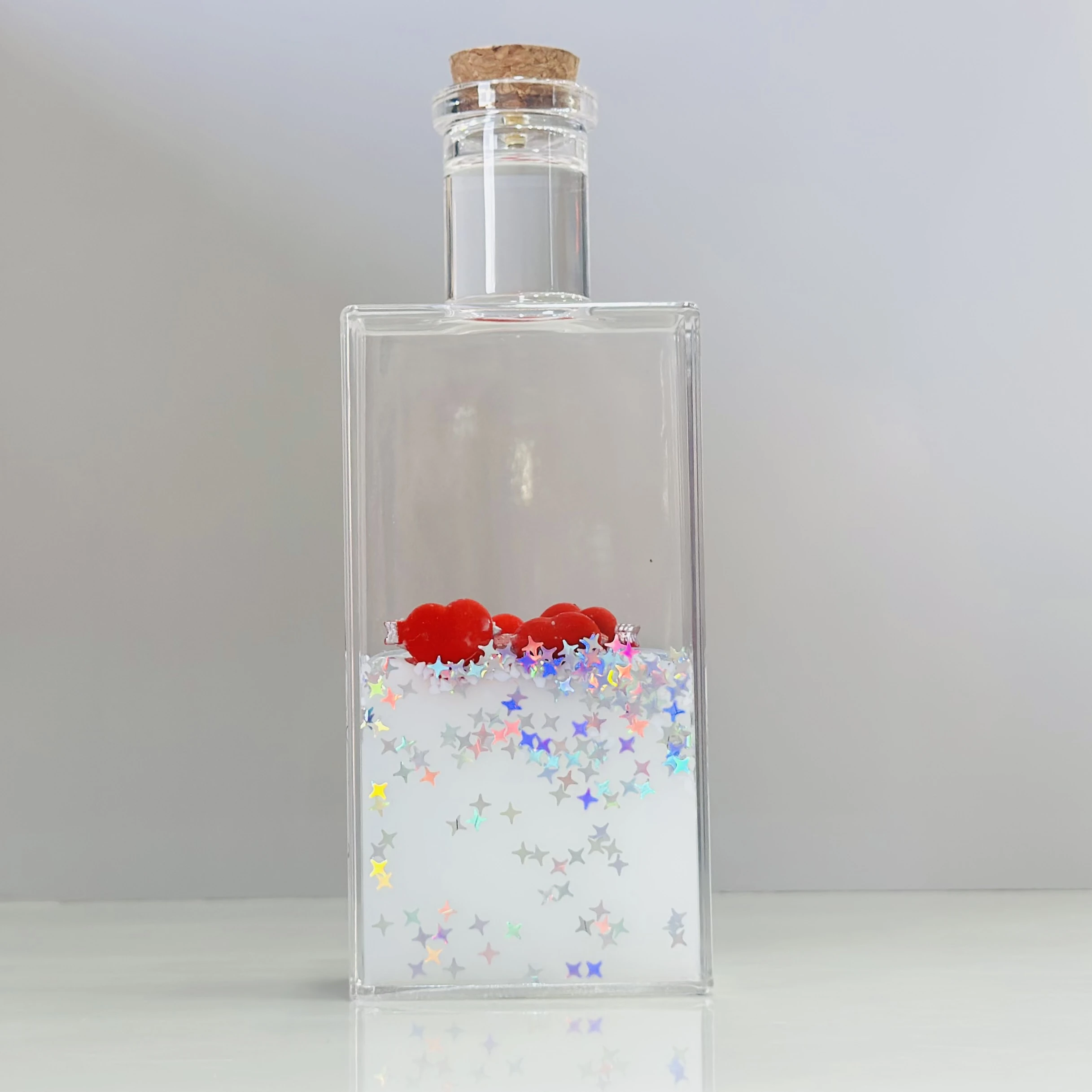 decorative fluid bottle with hearts and stars. (SKU-ATDL7R)