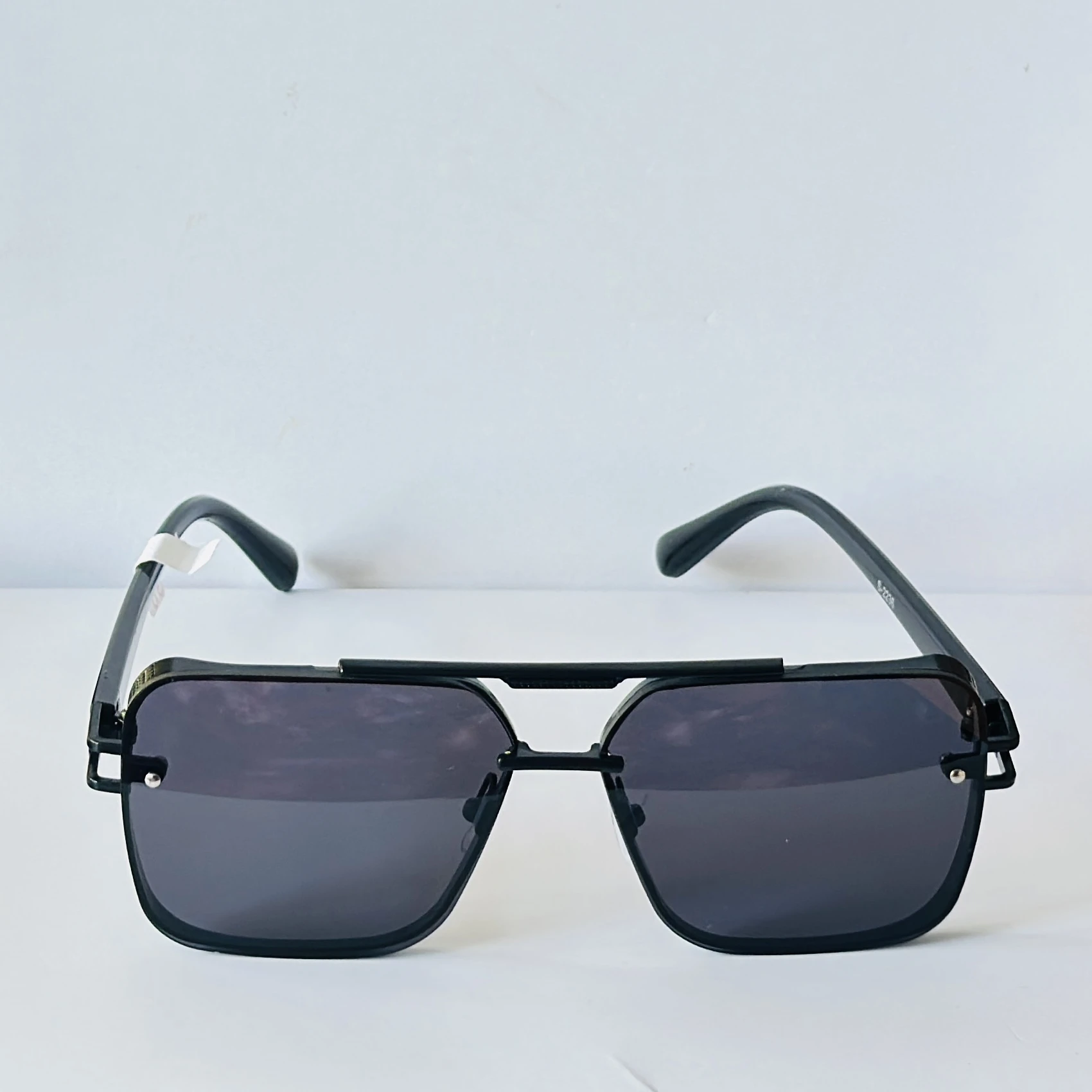 Black sunglasses feature a square frame