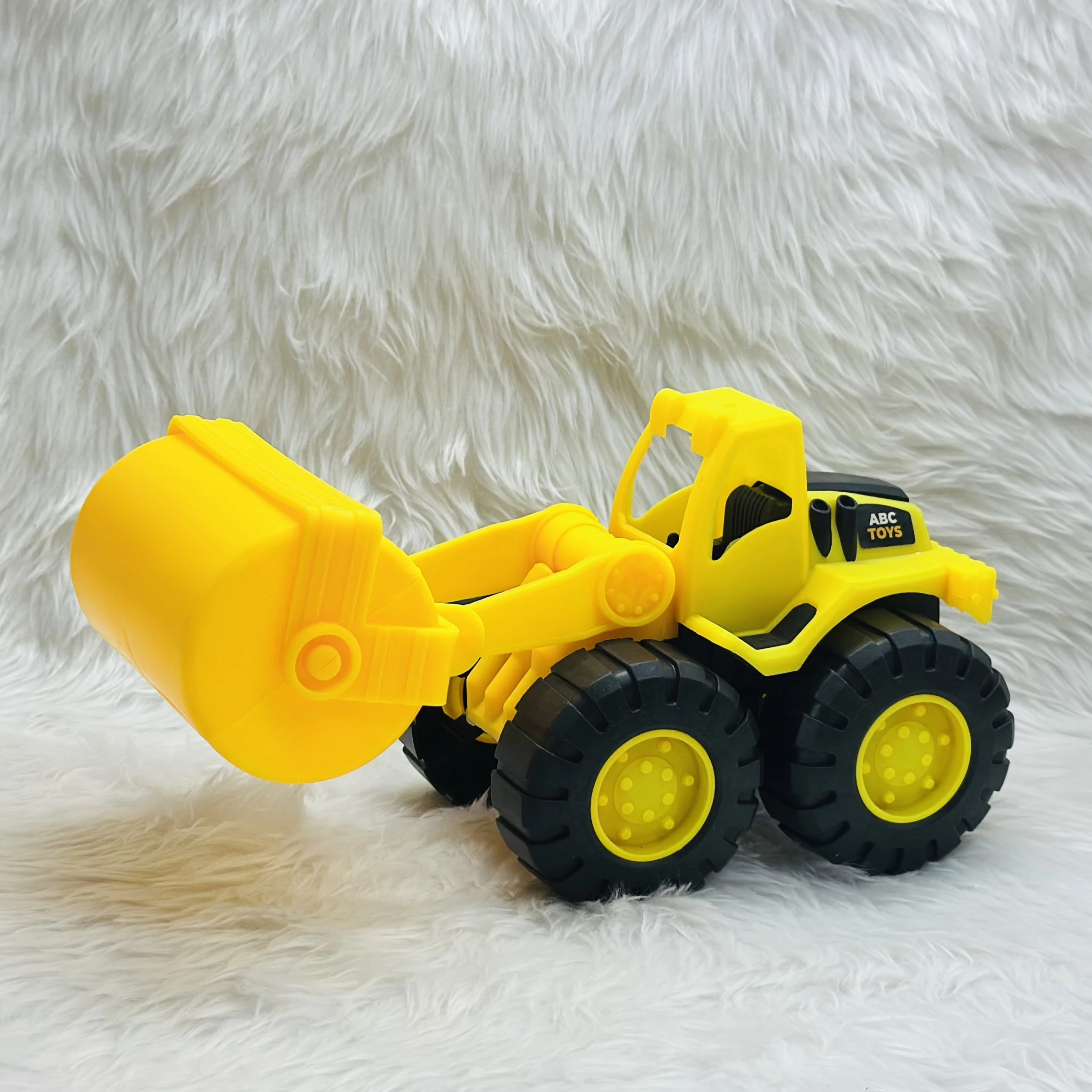 yellow toy construction vehicle, identified as a bulldozer or wheel loader,