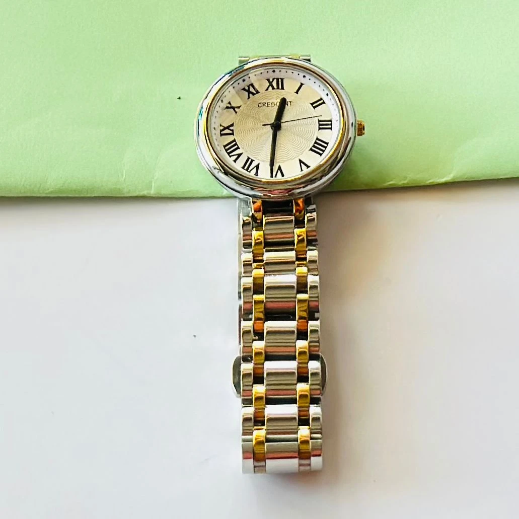 Crescent analog watch with a rectangular case and a two-tone (silver and gold) metal bracelet.