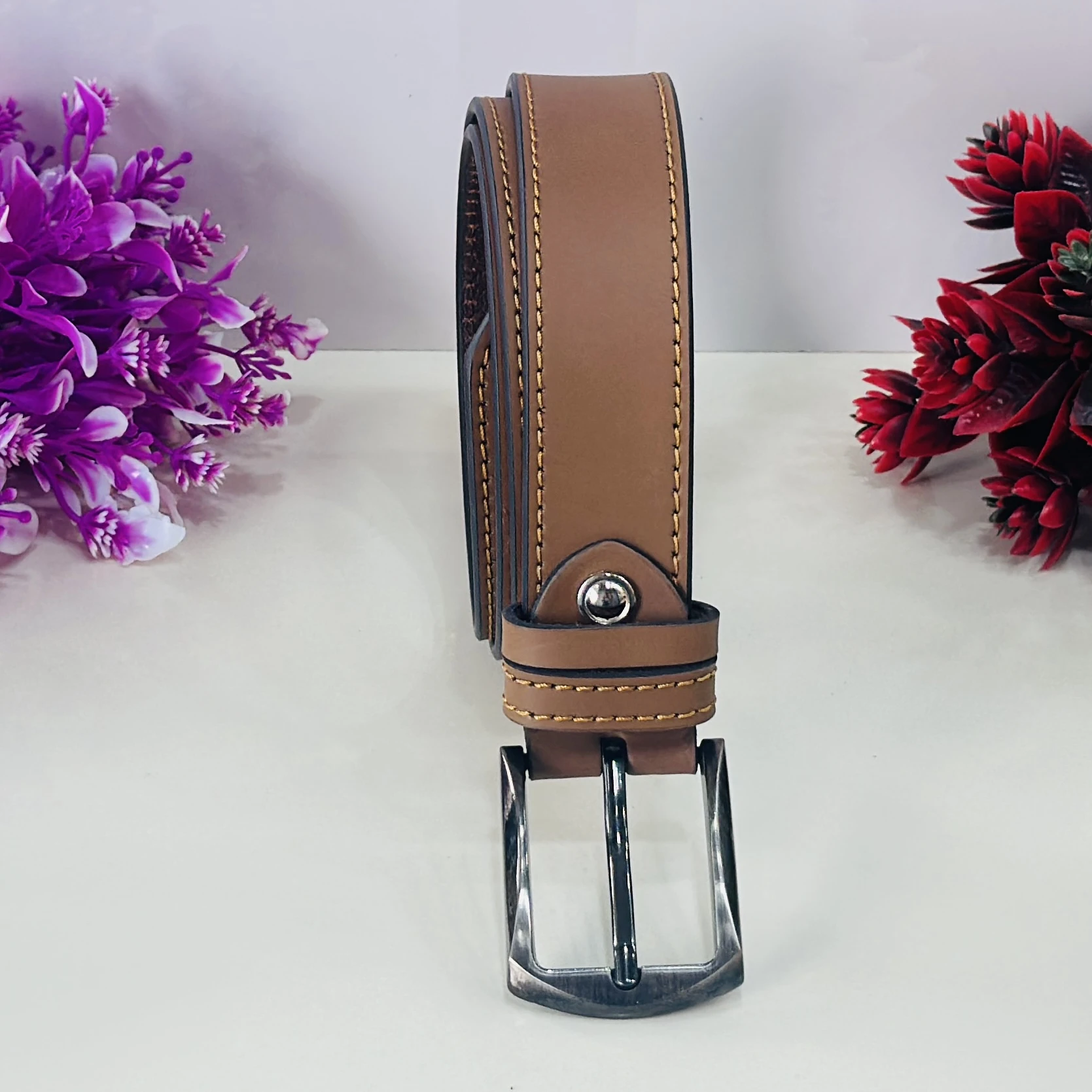 Brown leather belt with a metal buckle