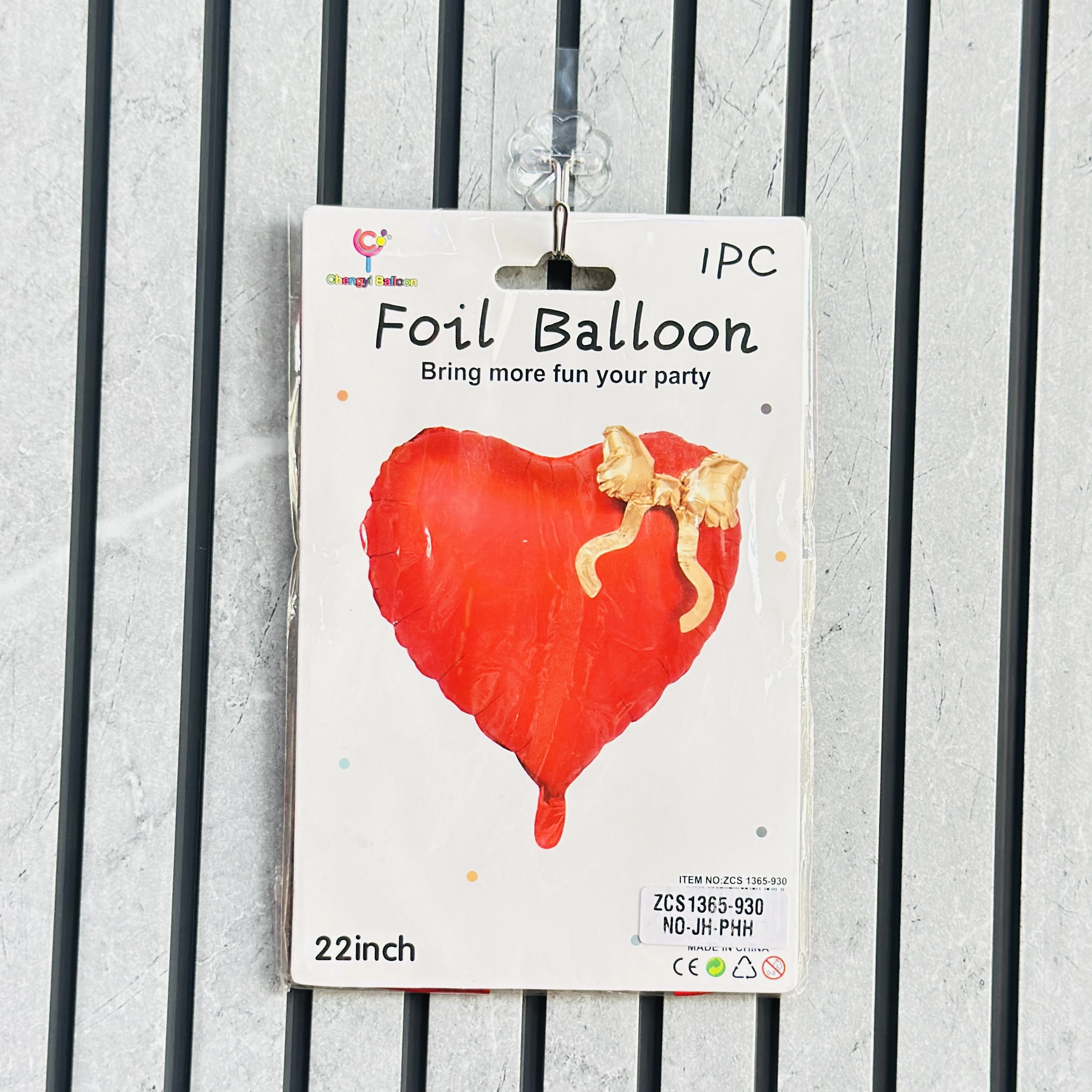 22-inch Chengyi Balloon red heart-shaped foil balloon with an attached gold bow.