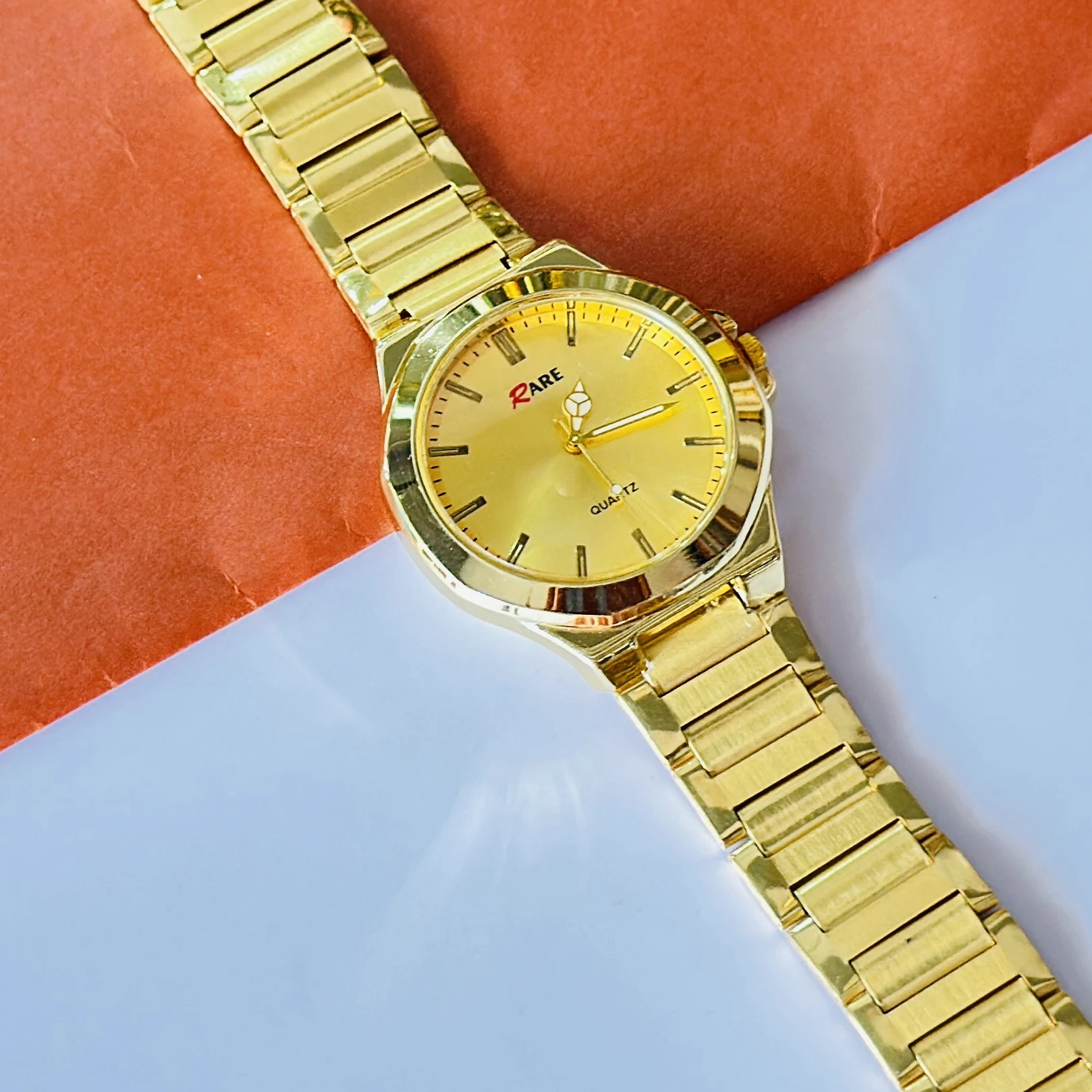 Gold coloured analogue watch