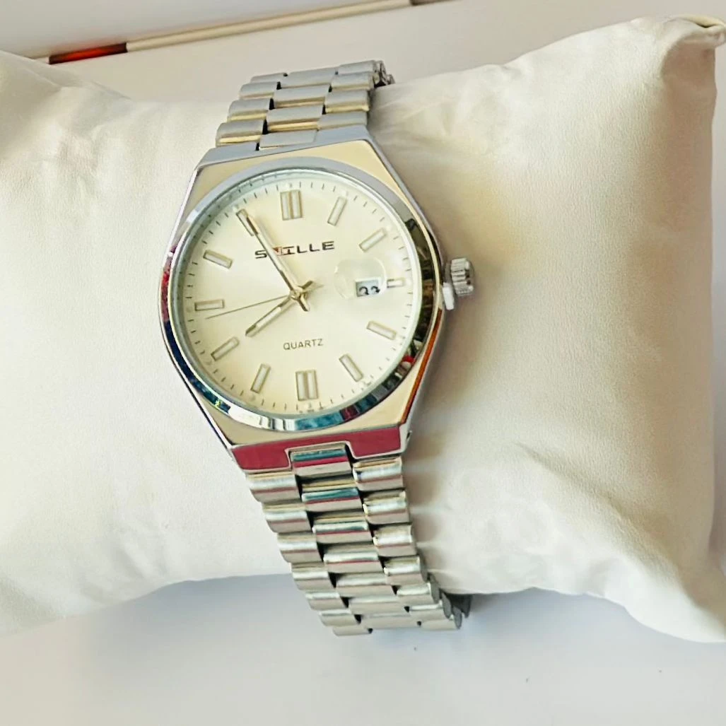 Snille analog quartz watch with a white dial and silver stainless steel strap.