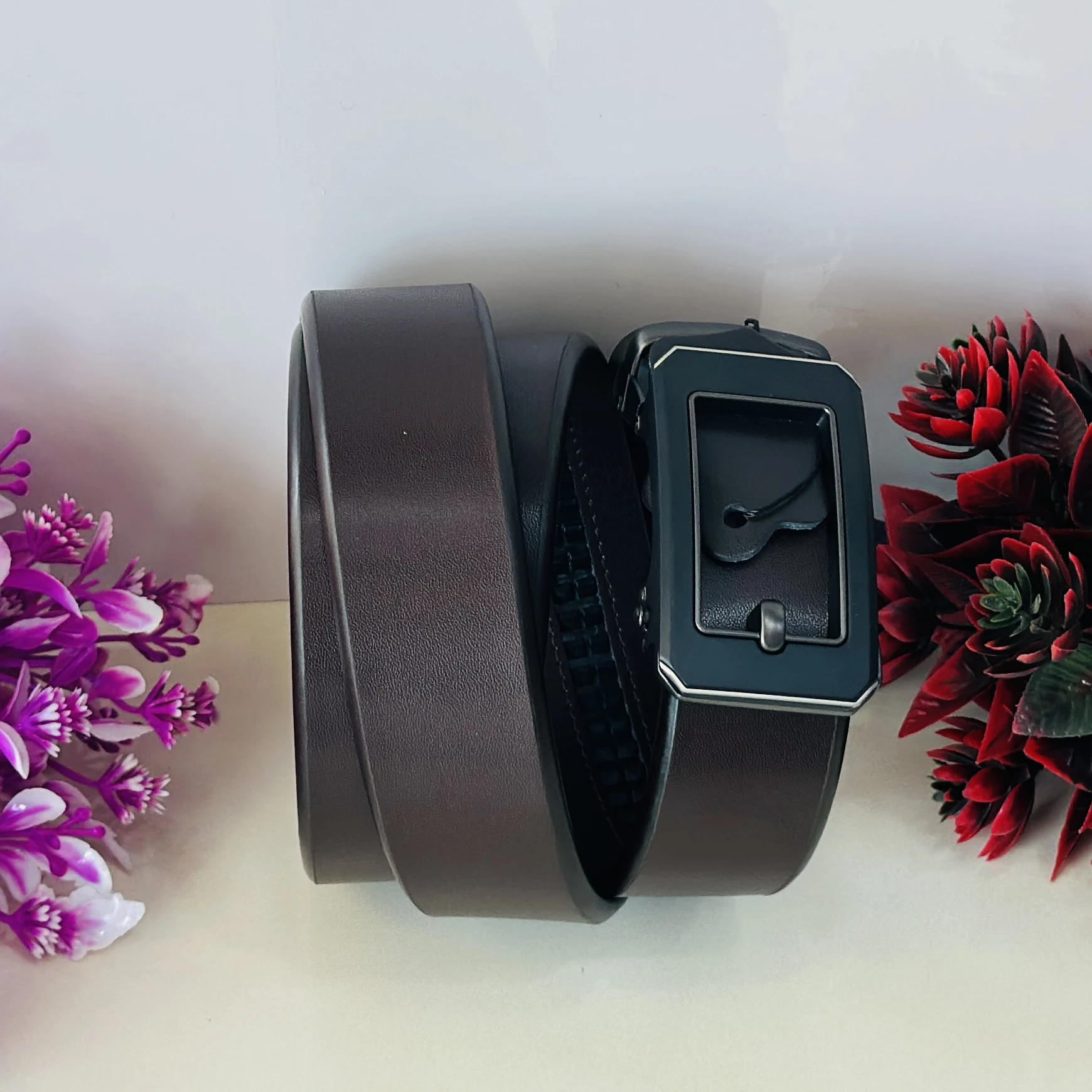 Brown leather auto-lock or ratchet buckle belt for men.