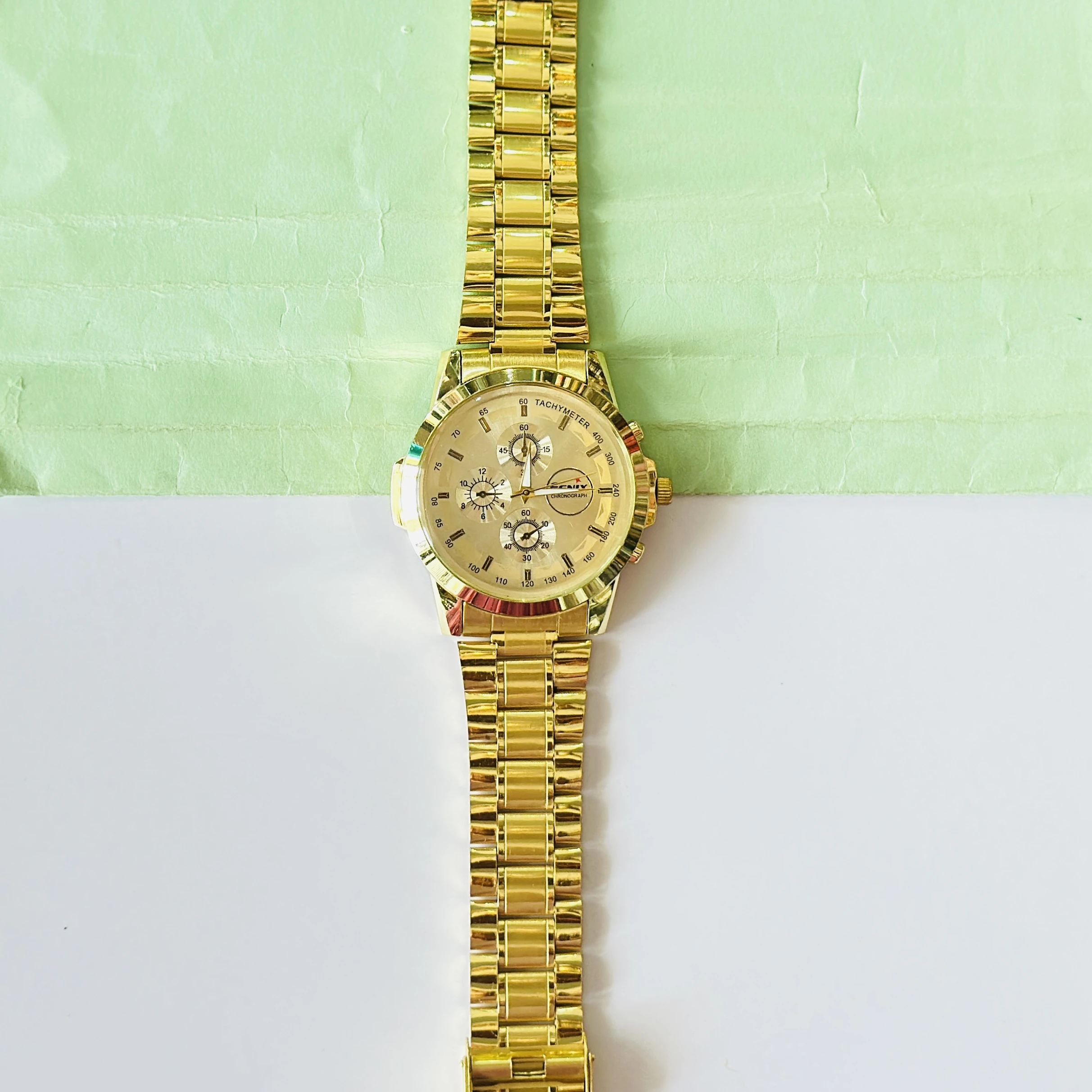 Gold coloured analogue watch
