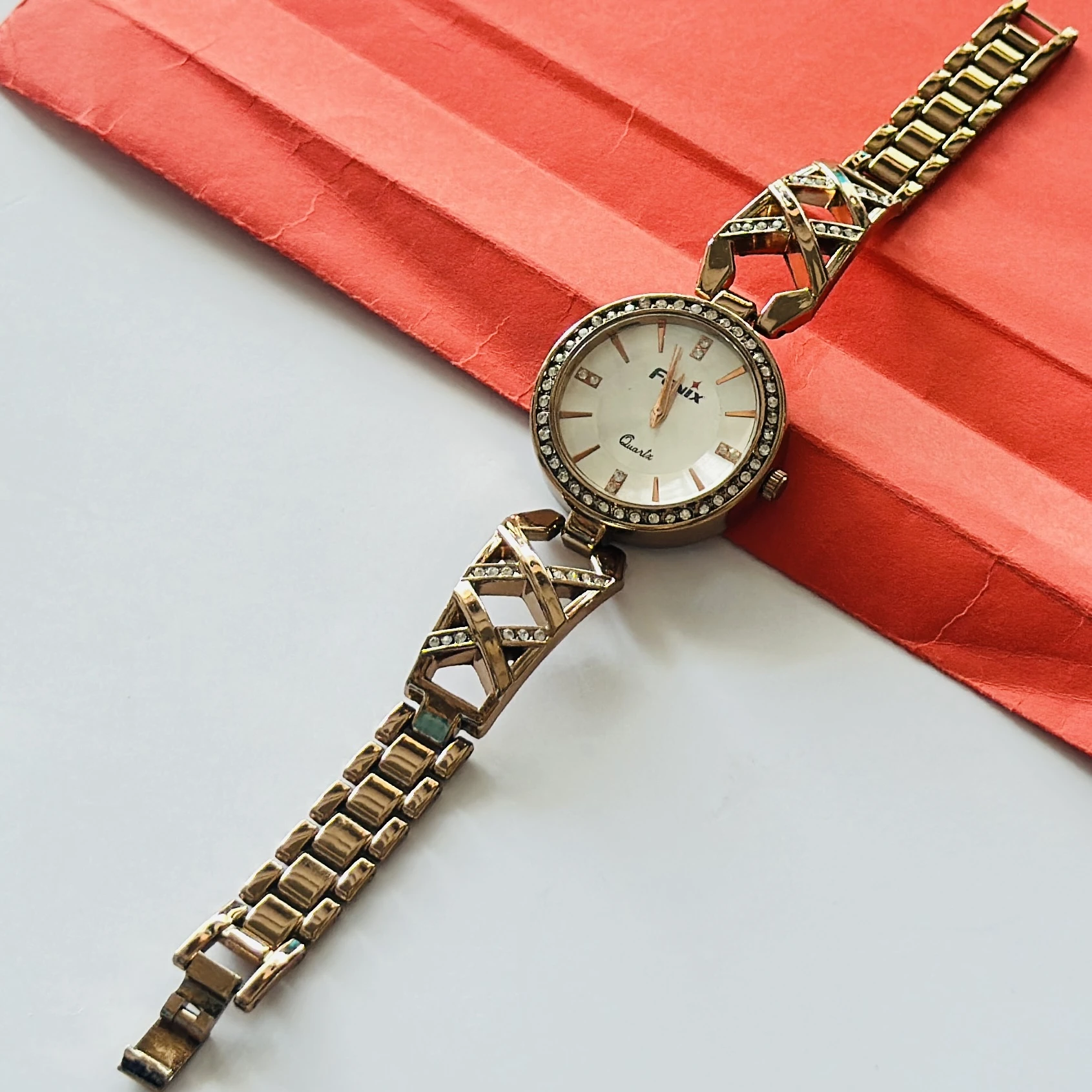 Rose gold toned jewelry watches with studded dials and cutout bracelet straps