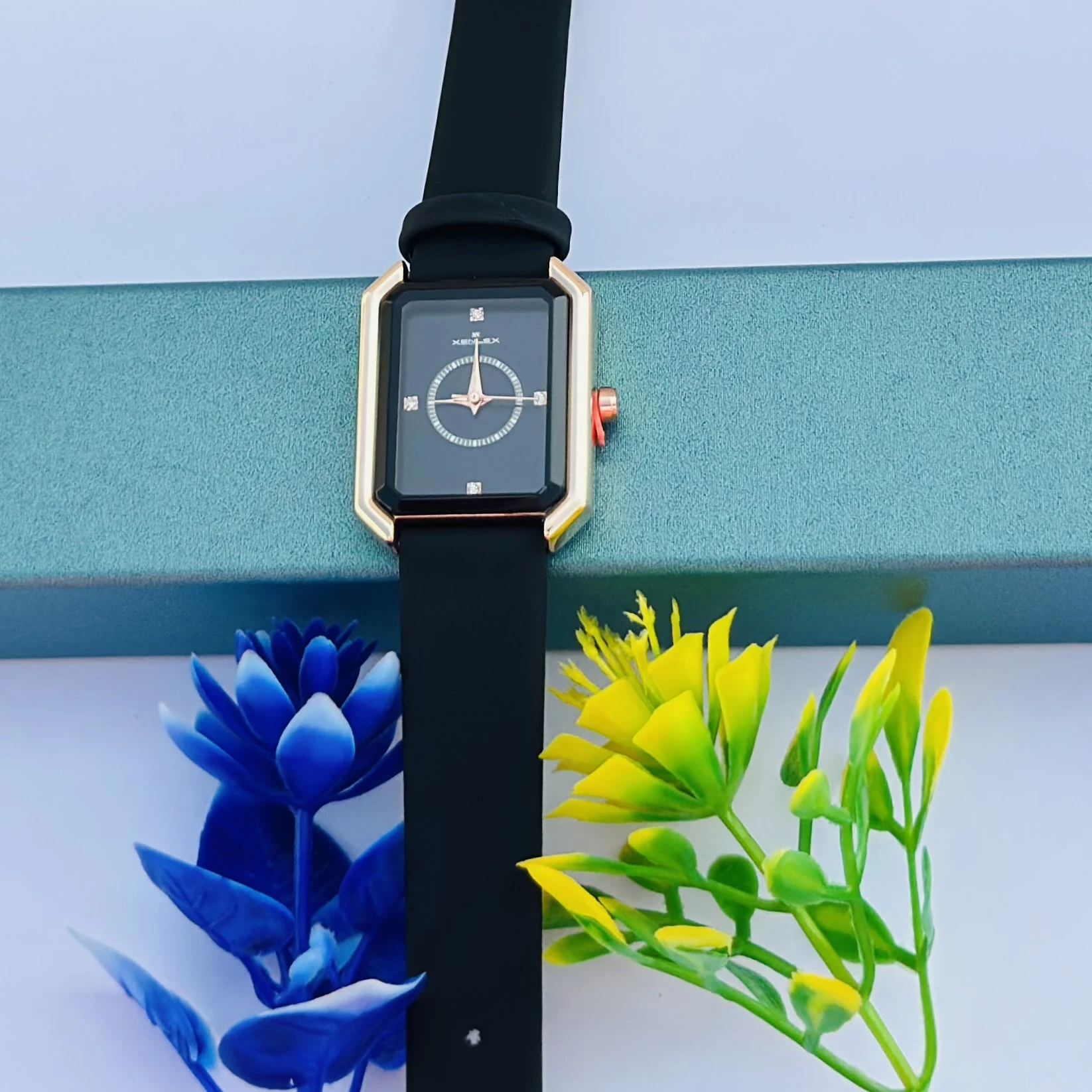 women's watch with a rectangular dial and a black strap.