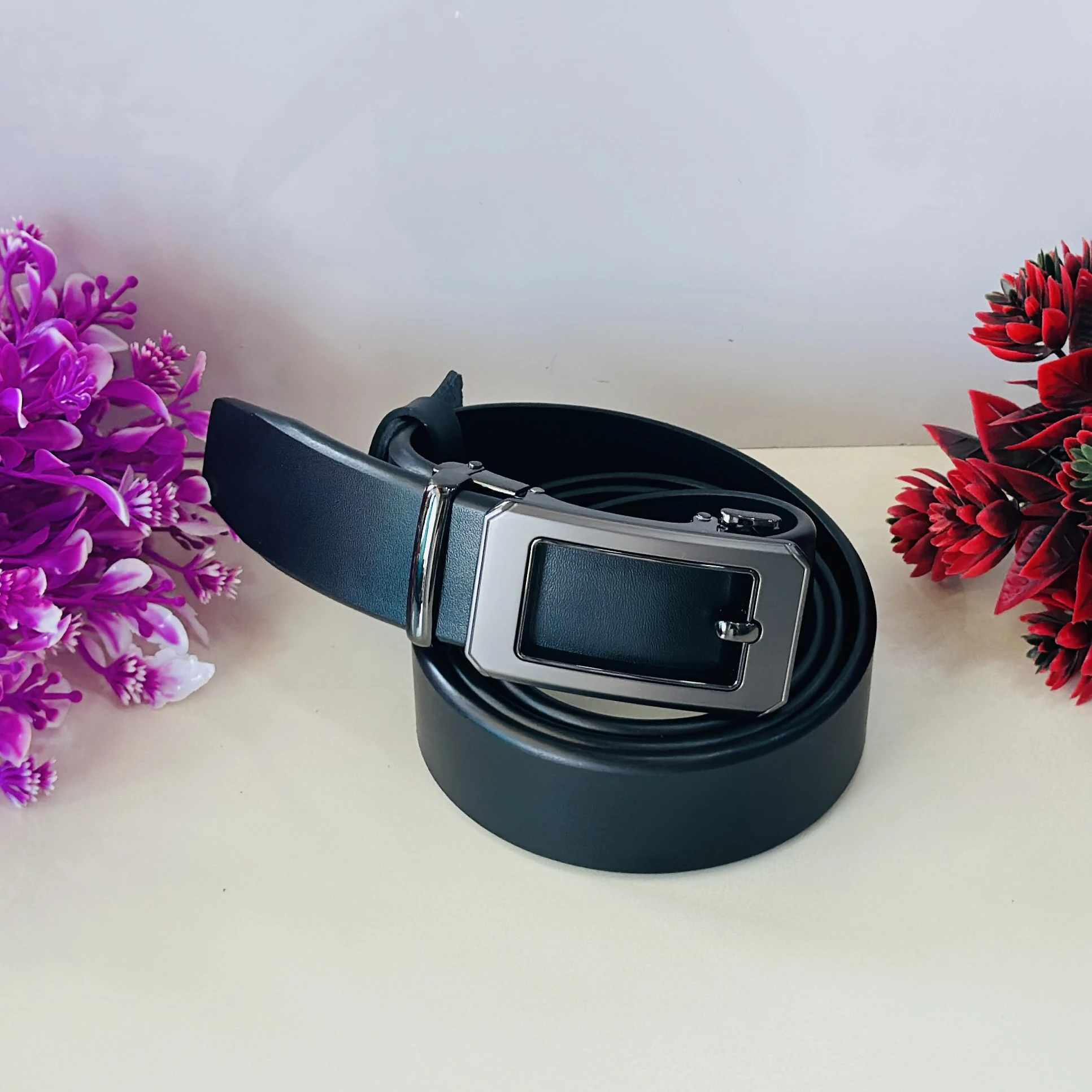 Black leather auto-lock or ratchet buckle belt for men.