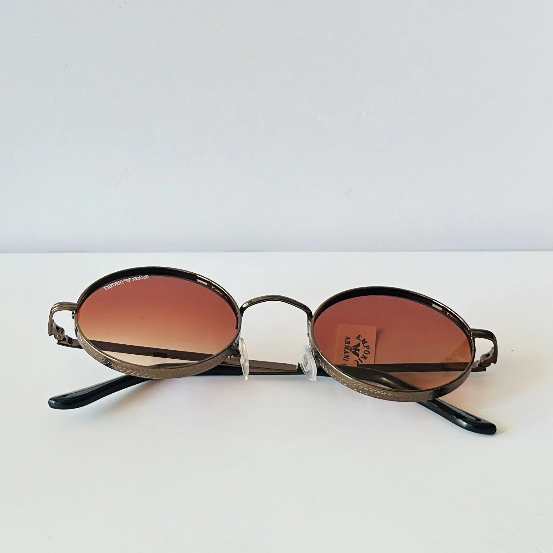 sunglasses are Emporio Armani round-frame
