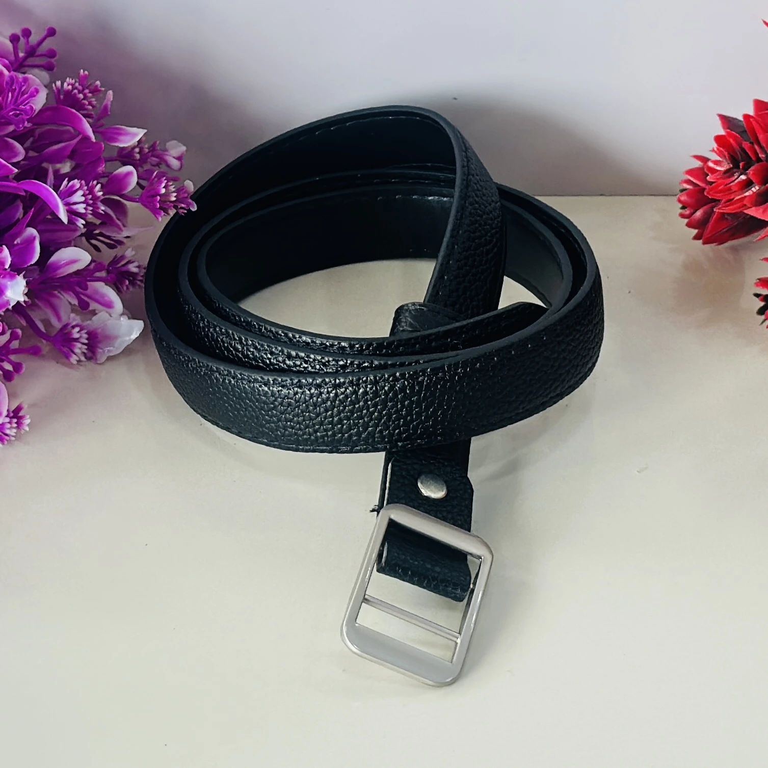 Black leather belt with a metal pin buckle.