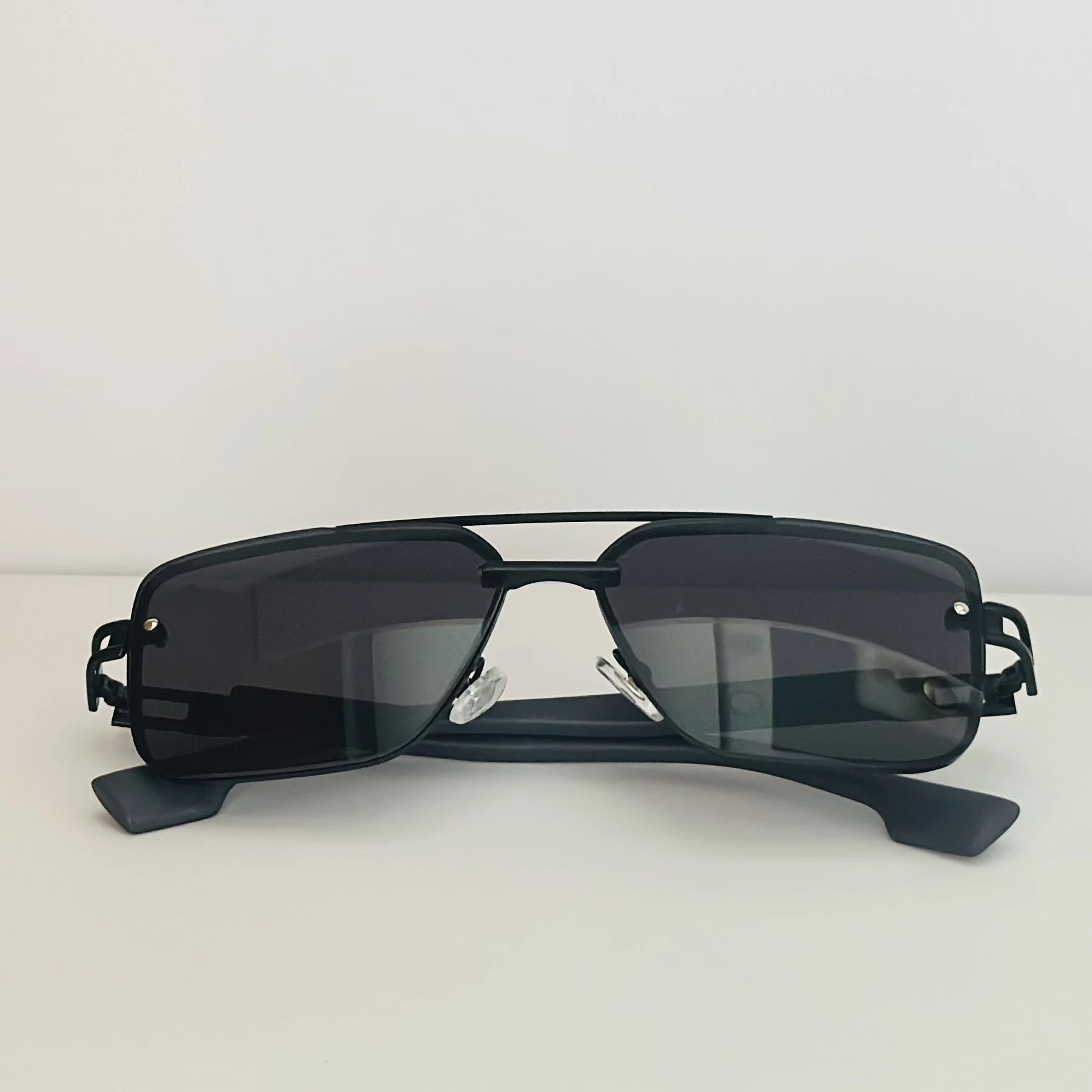 pair of black metal rectangular sunglasses.