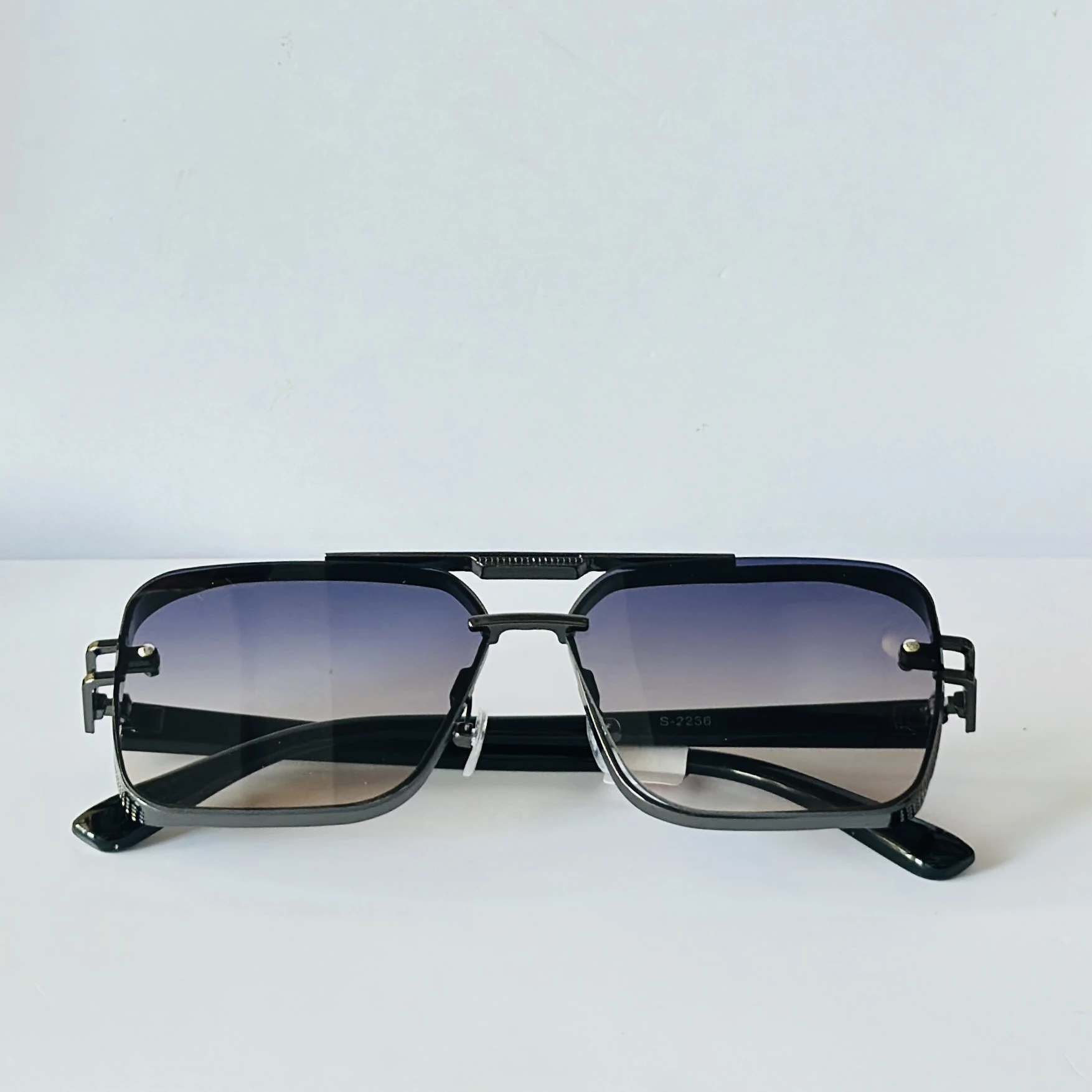 appear to be retro square or modern pilot-style sunglasses for men