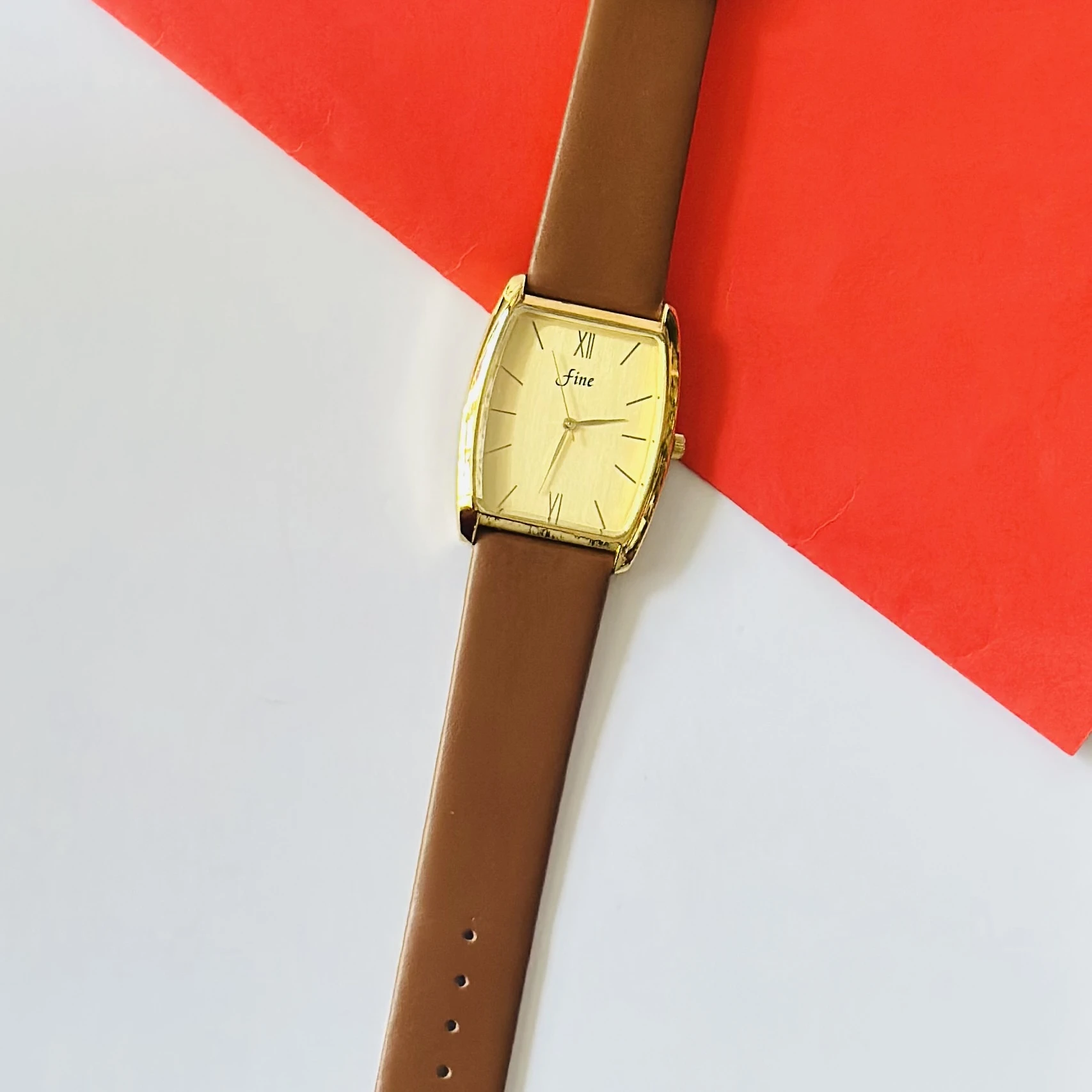 Gold toned GEDI women's quartz watch with a brown leather strap.