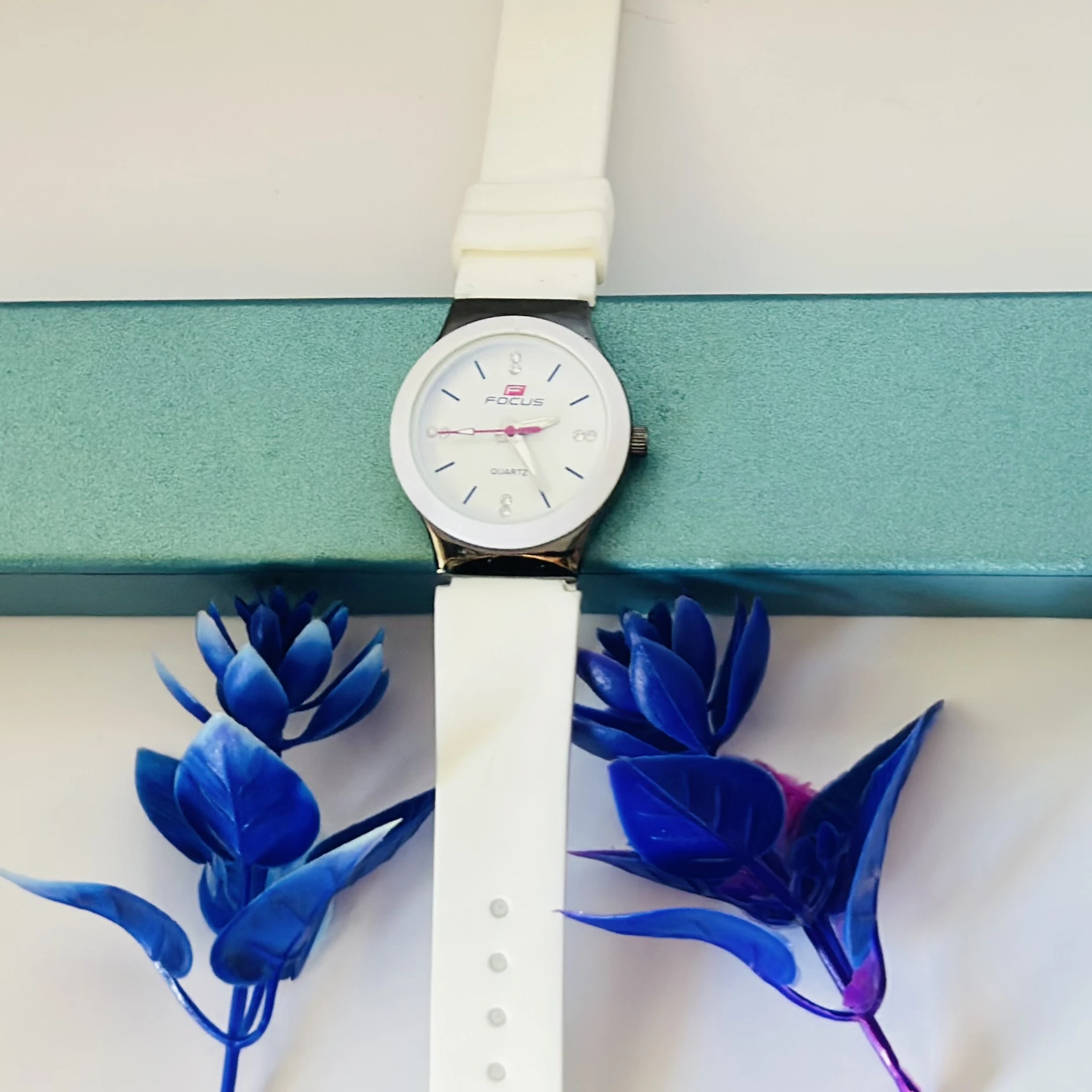 White Focus quartz analog watch for women with a white leather strap.