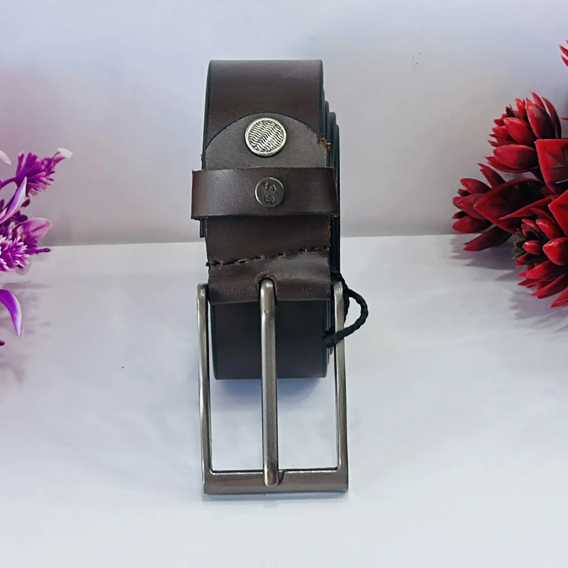 Brown leather belt with a metal buckle