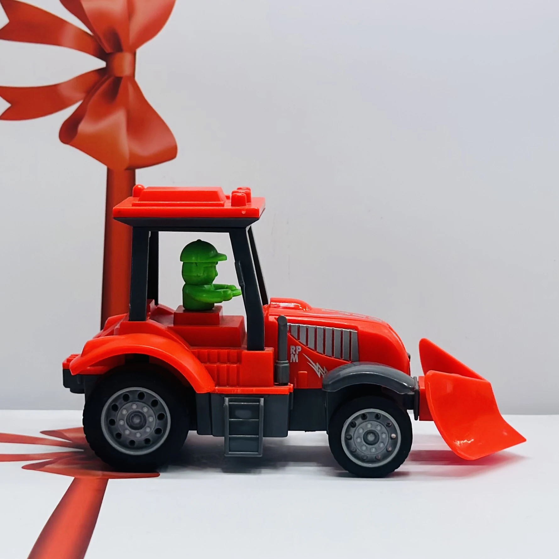 Red plastic toy tractor