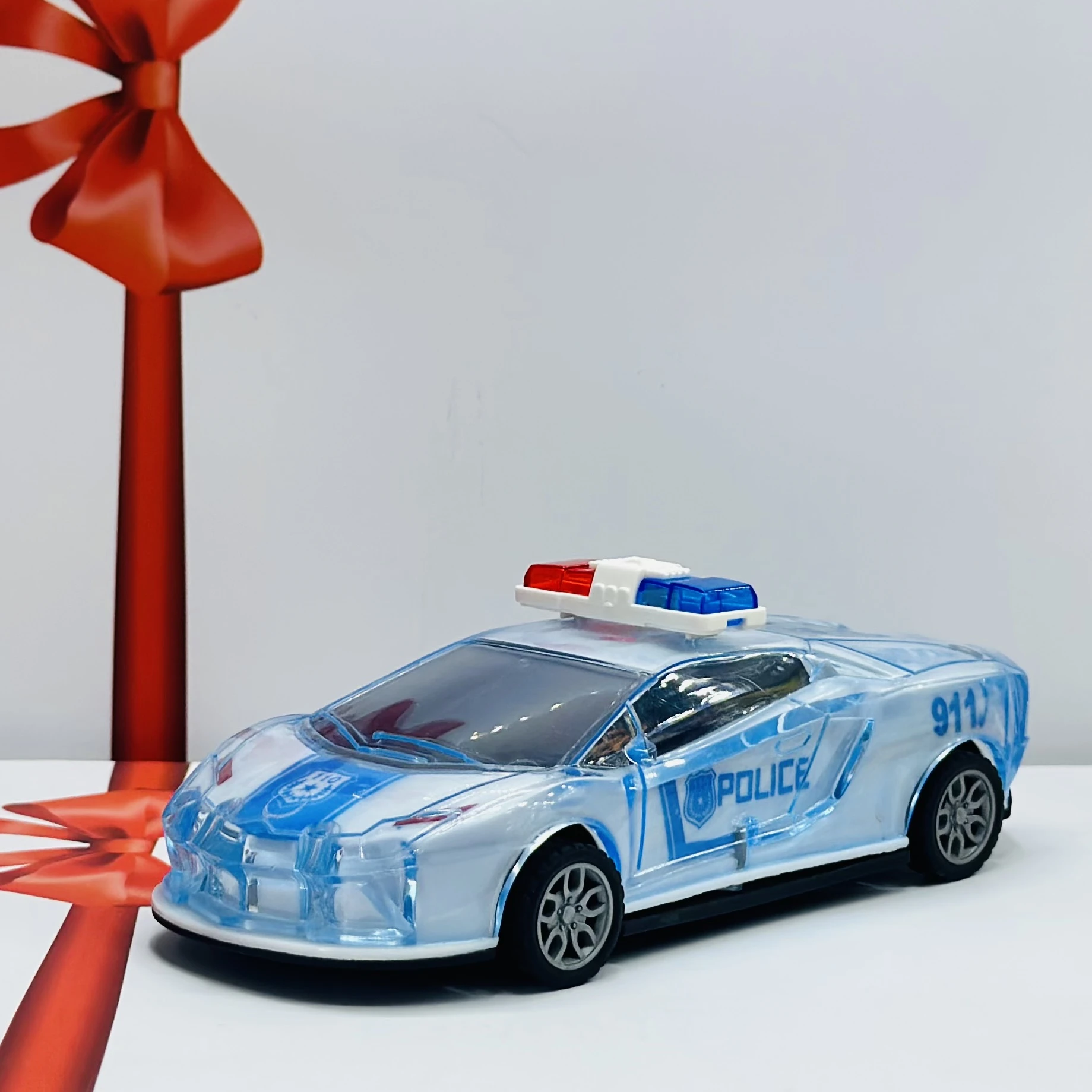 Toy police car with a transparent body and light-up features.