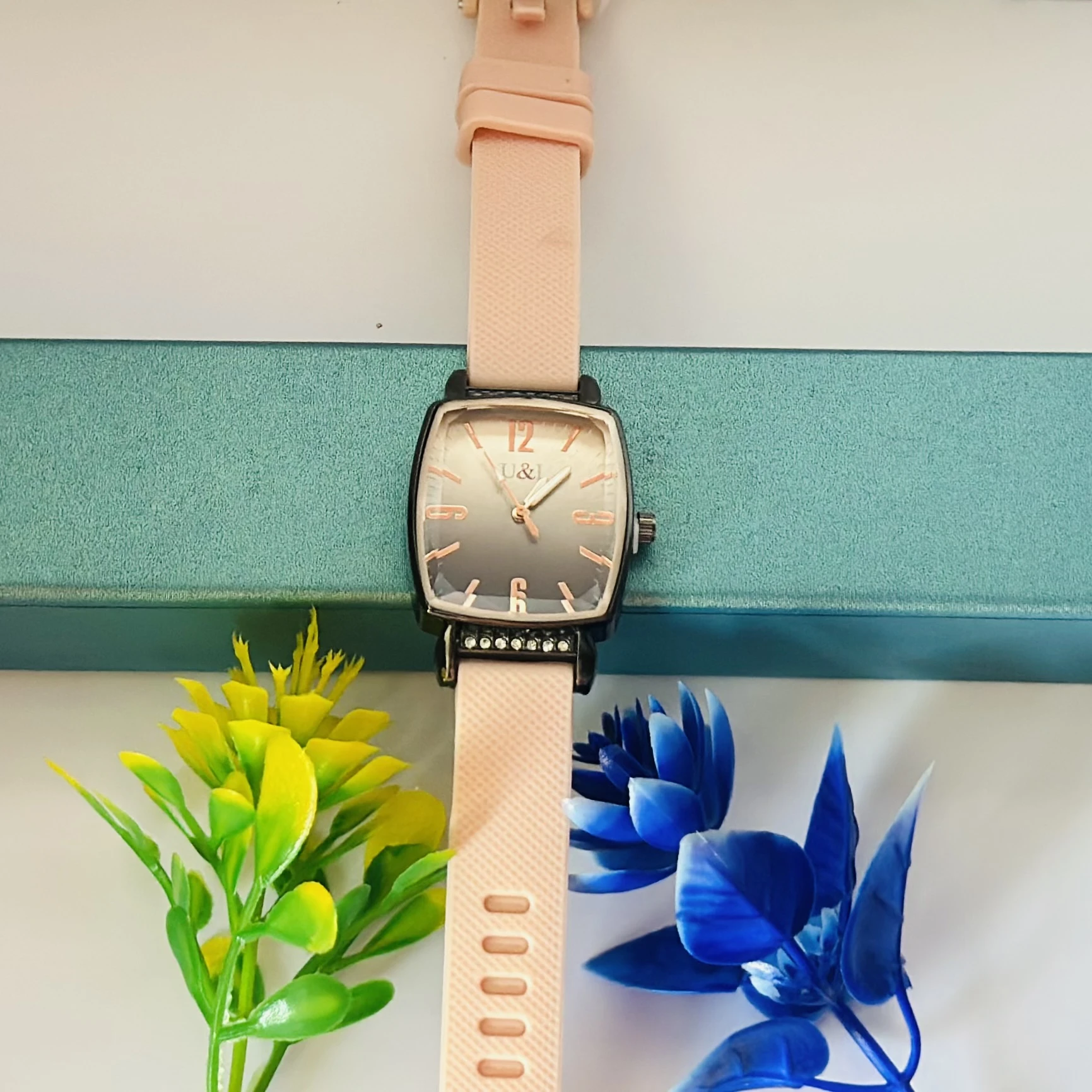 women's analog watch with a pink silicone strap and a rose gold-tone case and dial