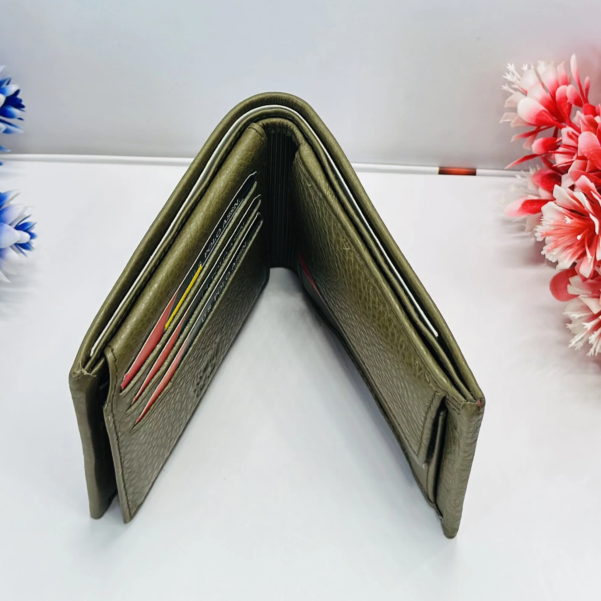 U.S. Polo Assn. men's bi-fold wallet in olive green grained leather.