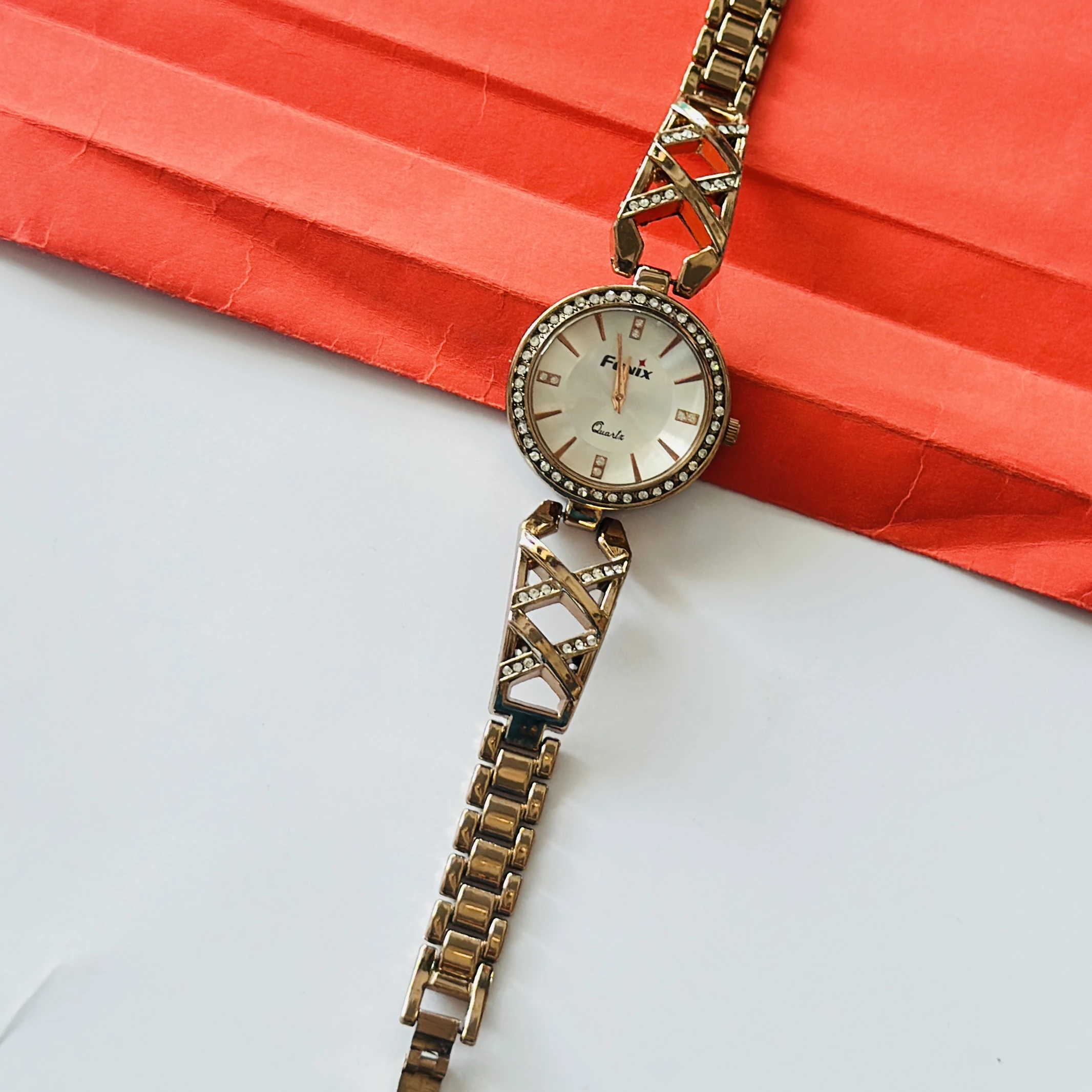 Rose gold toned jewelry watches with studded dials and cutout bracelet straps