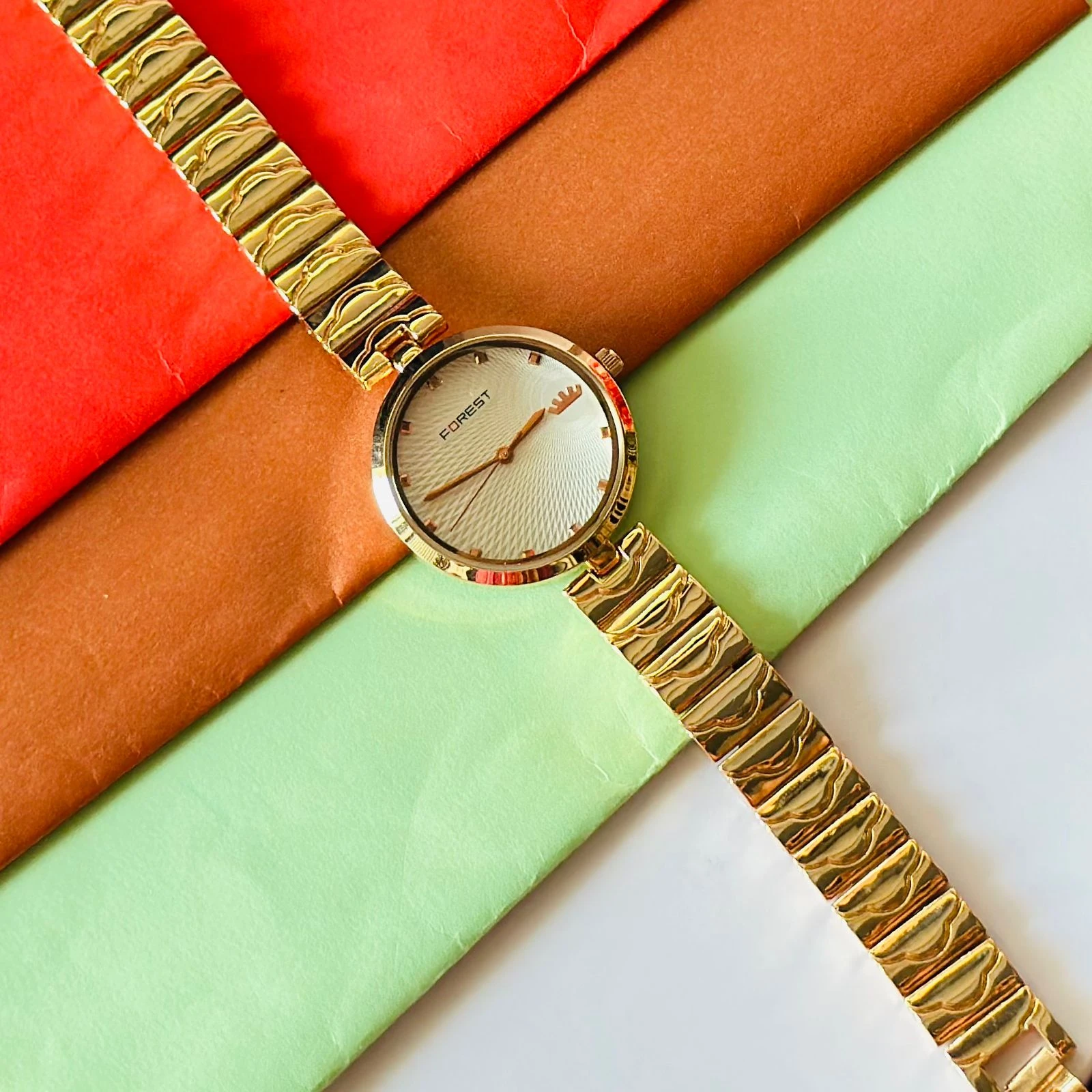 analog watch with a white dial and a rose gold metal strap
