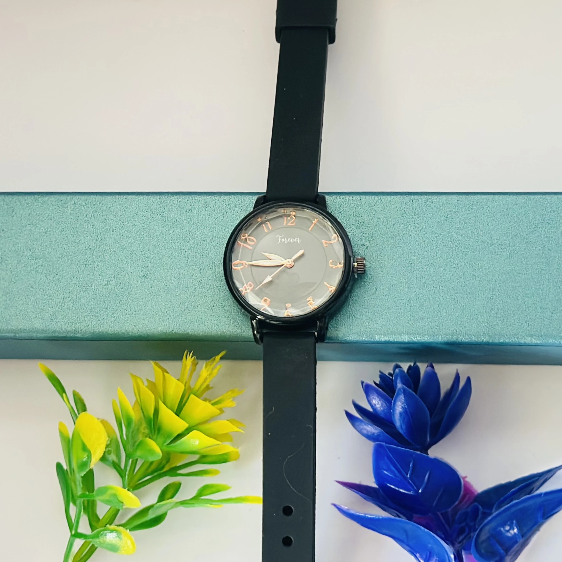 women's analog quartz watch with a white dial and black strap.