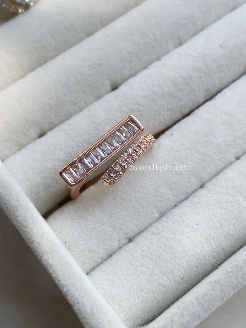modern minimalist gold ring featuring a baguette diamond bar design.