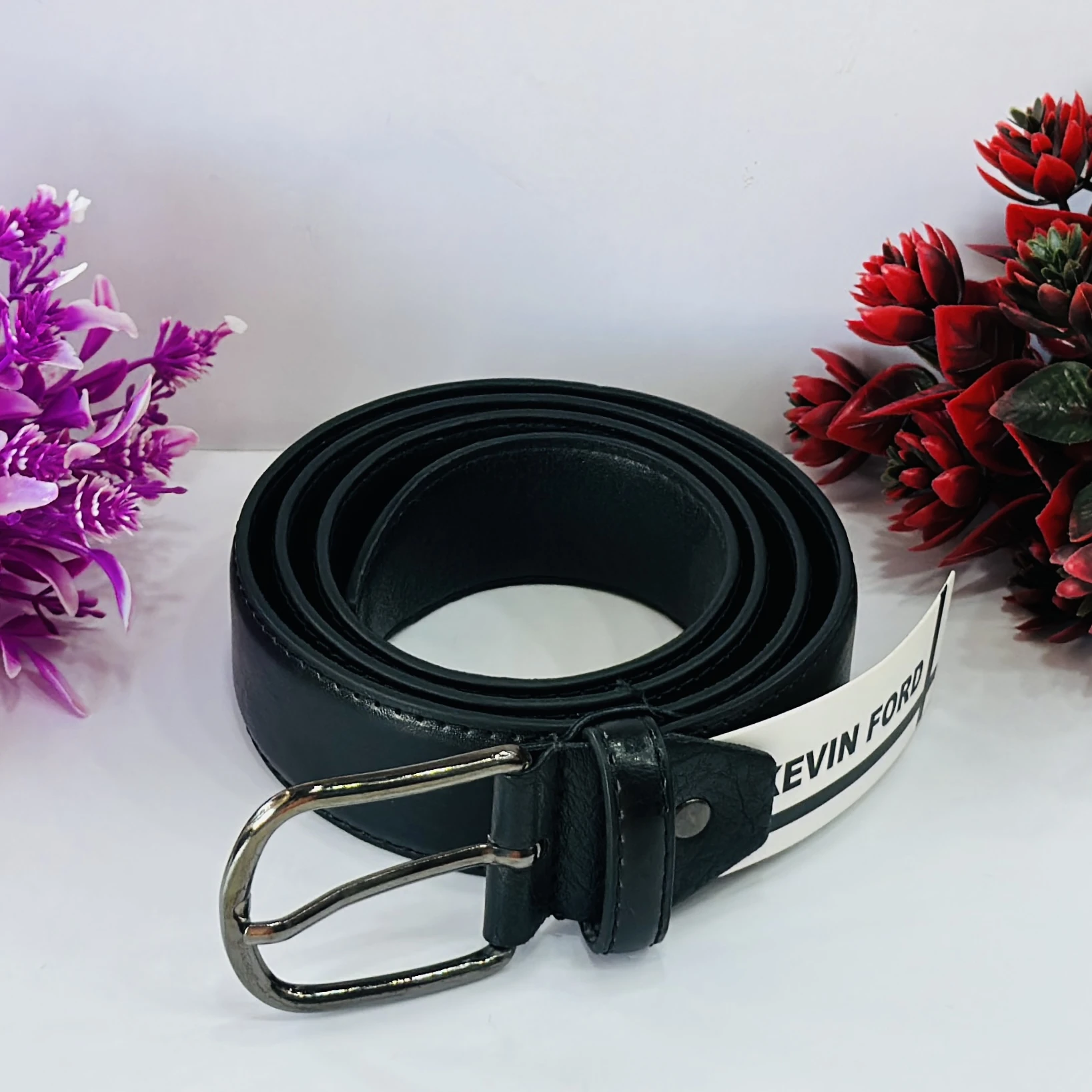 Black leather belt with a metal buckle.