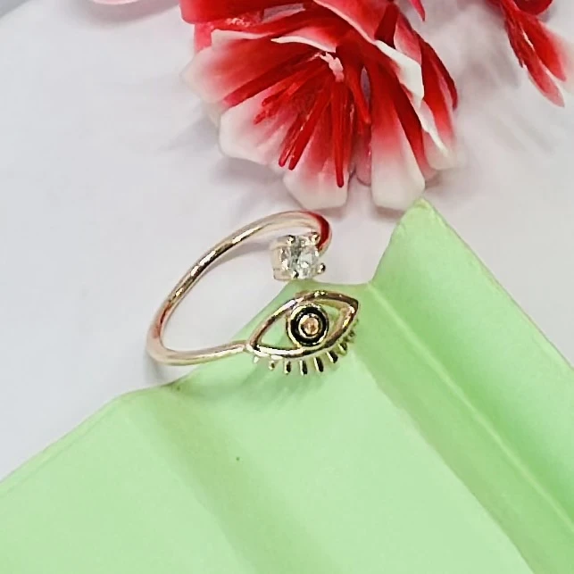 An adjustable gold-toned evil eye ring featuring a cubic zirconia accent.