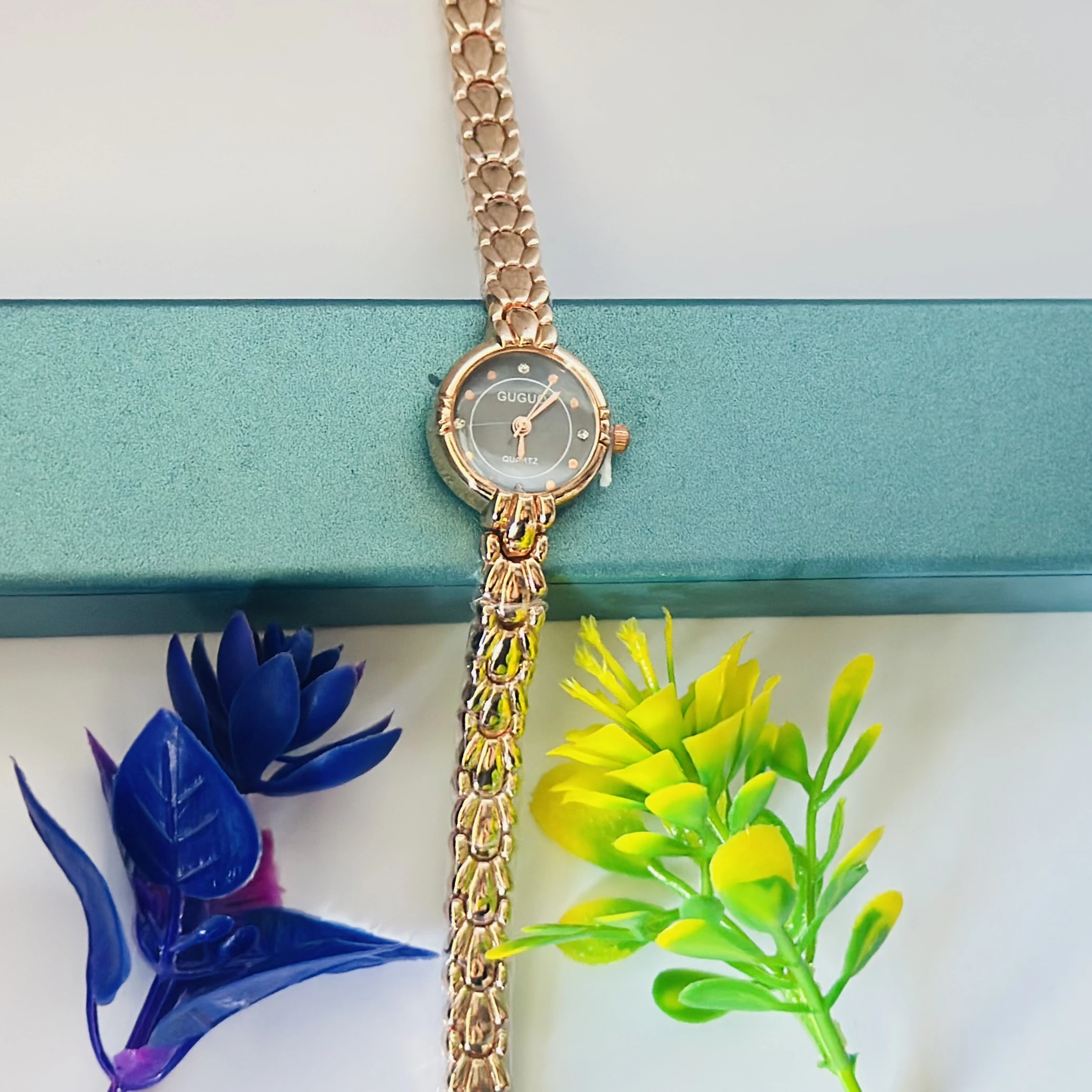 analog women's watch with a rose gold-toned metal strap.