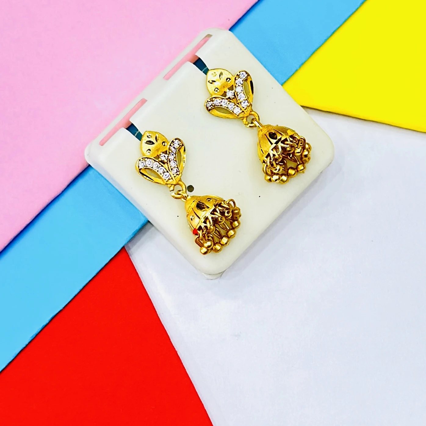 pair of ornate gold jhumka earrings