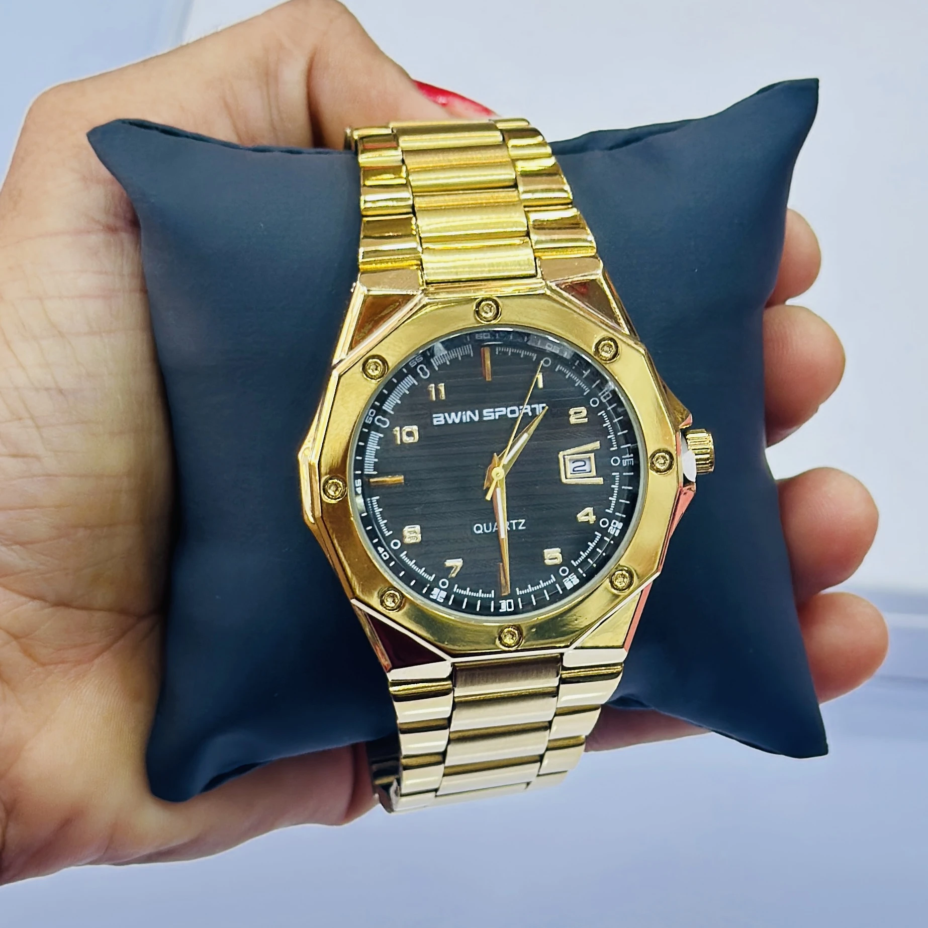 Gold coloured analogue watch