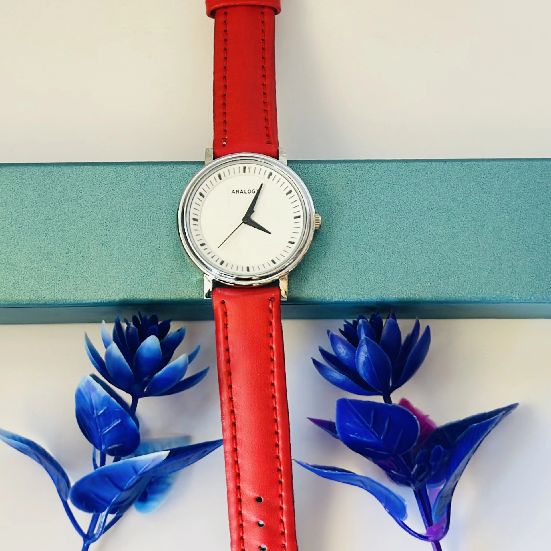 Red  analog watch with a red strap.