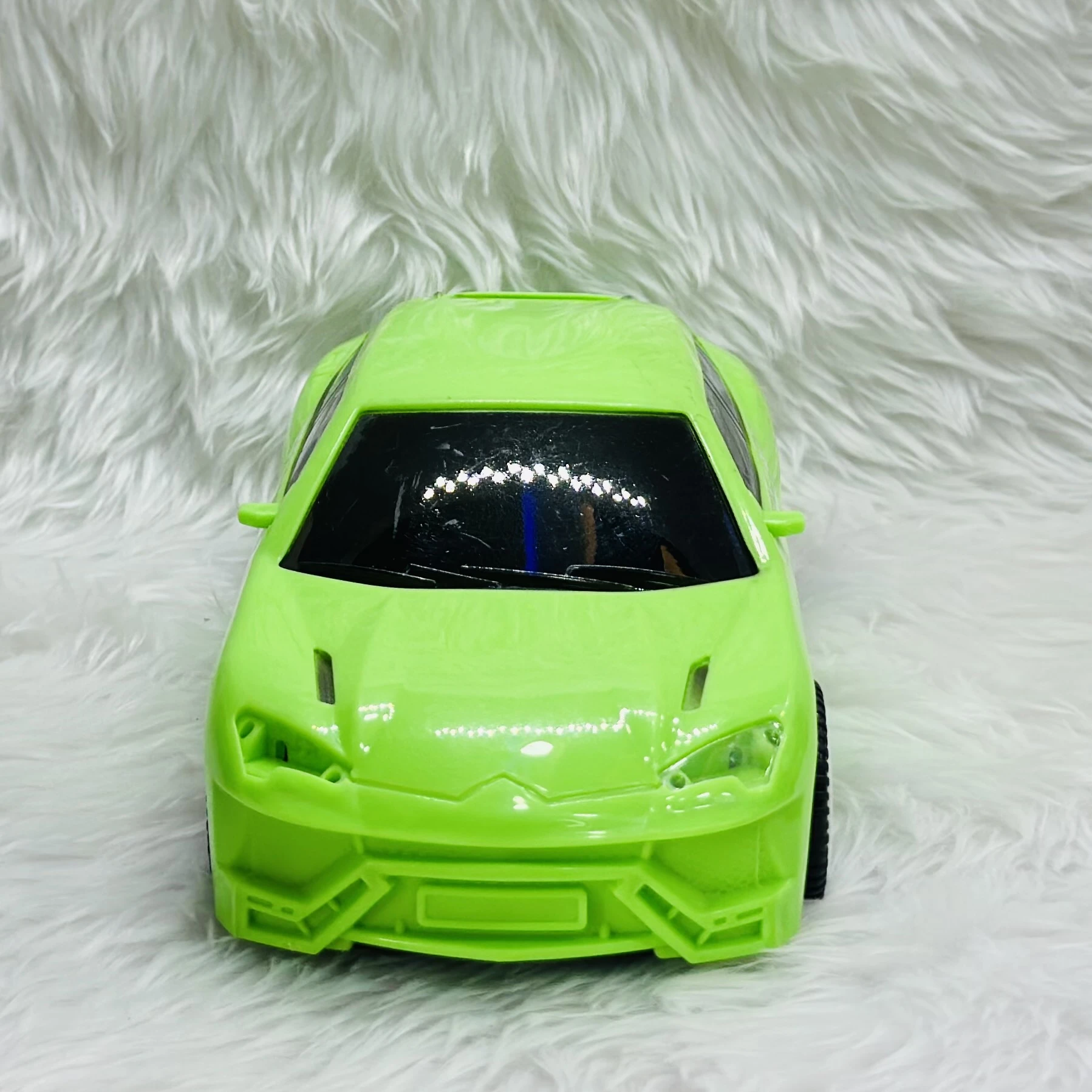 Green toy car, which is a model of a Lamborghini Urus SUV.