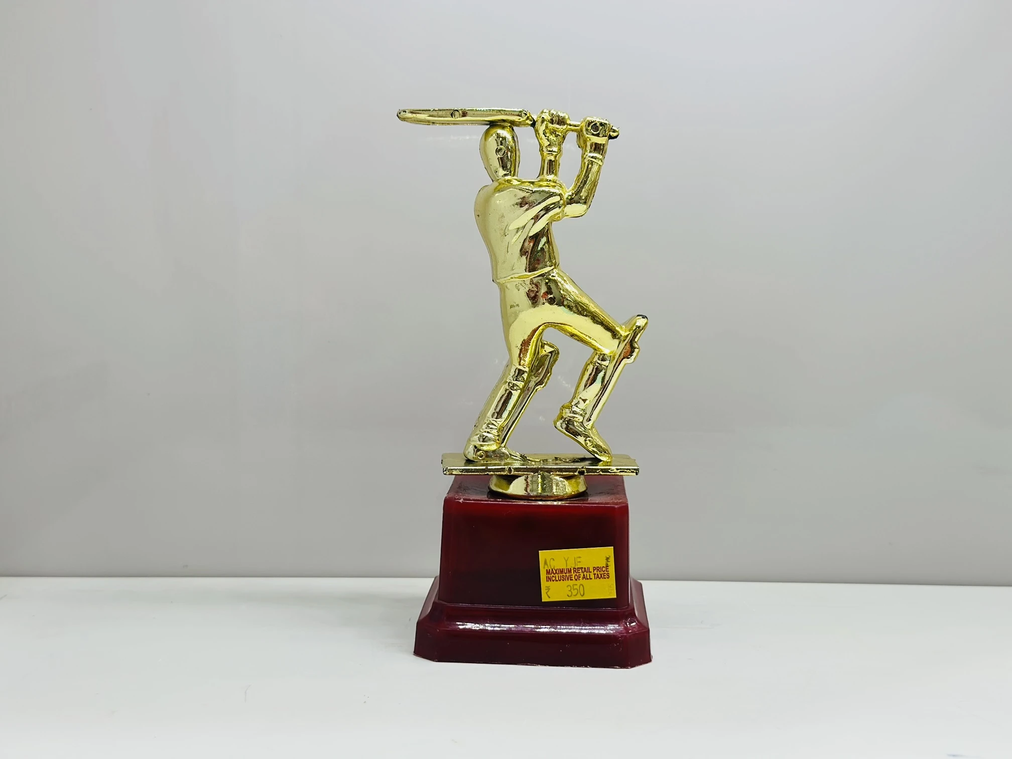 cricket trophy featuring a batsman figure.