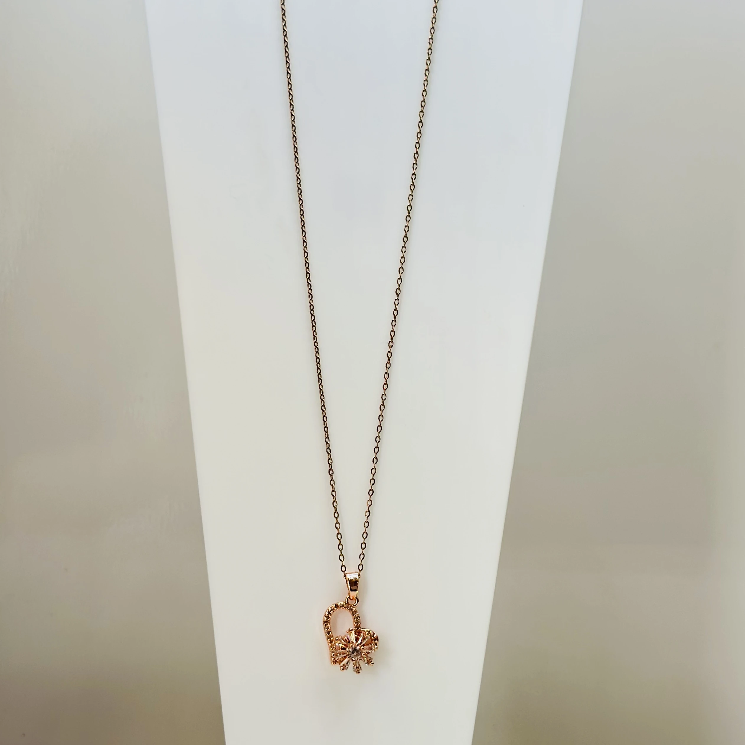 Gold plated nwith a rhinestone-studded butterfly charm pendant.