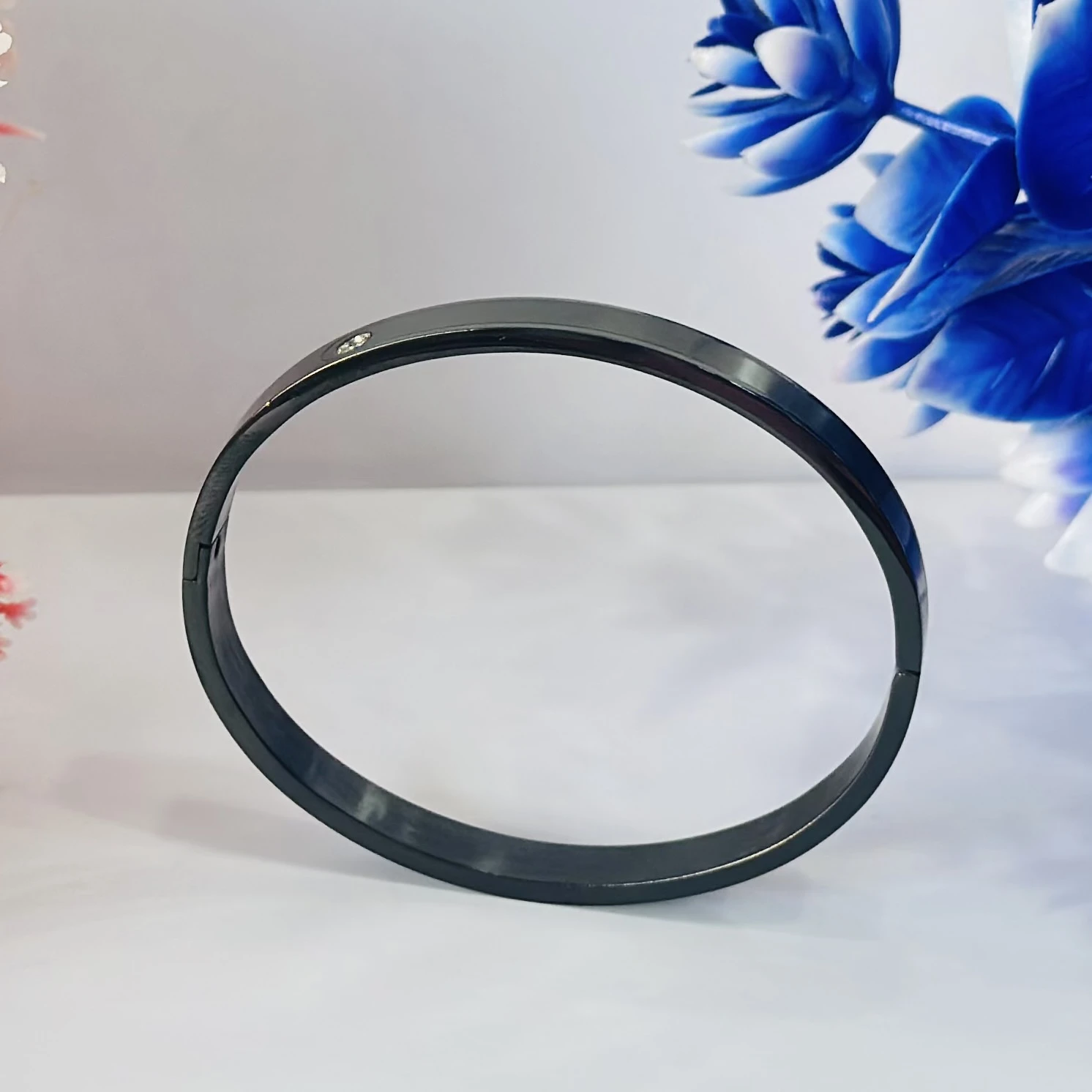 Black stainless steel kada bracelet with a diamond accent.