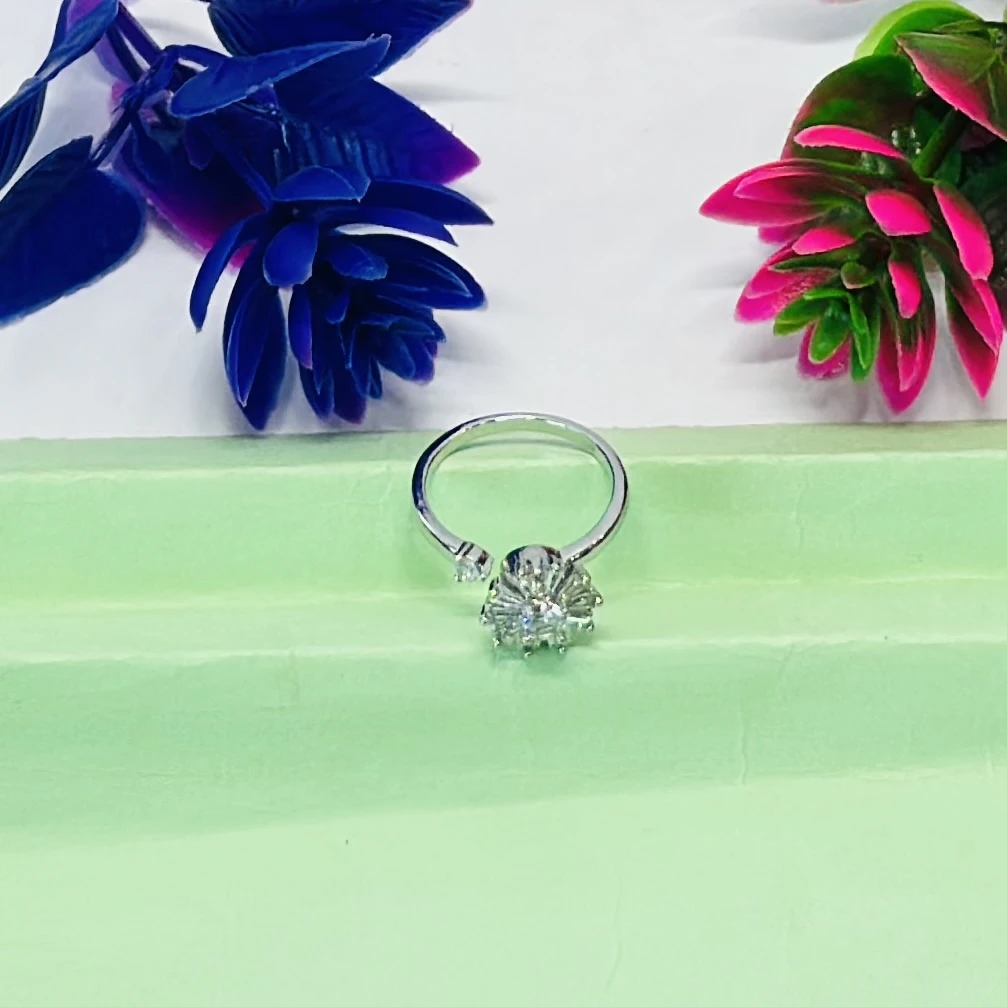 Silver toe ring featuring a white zircon floral design.