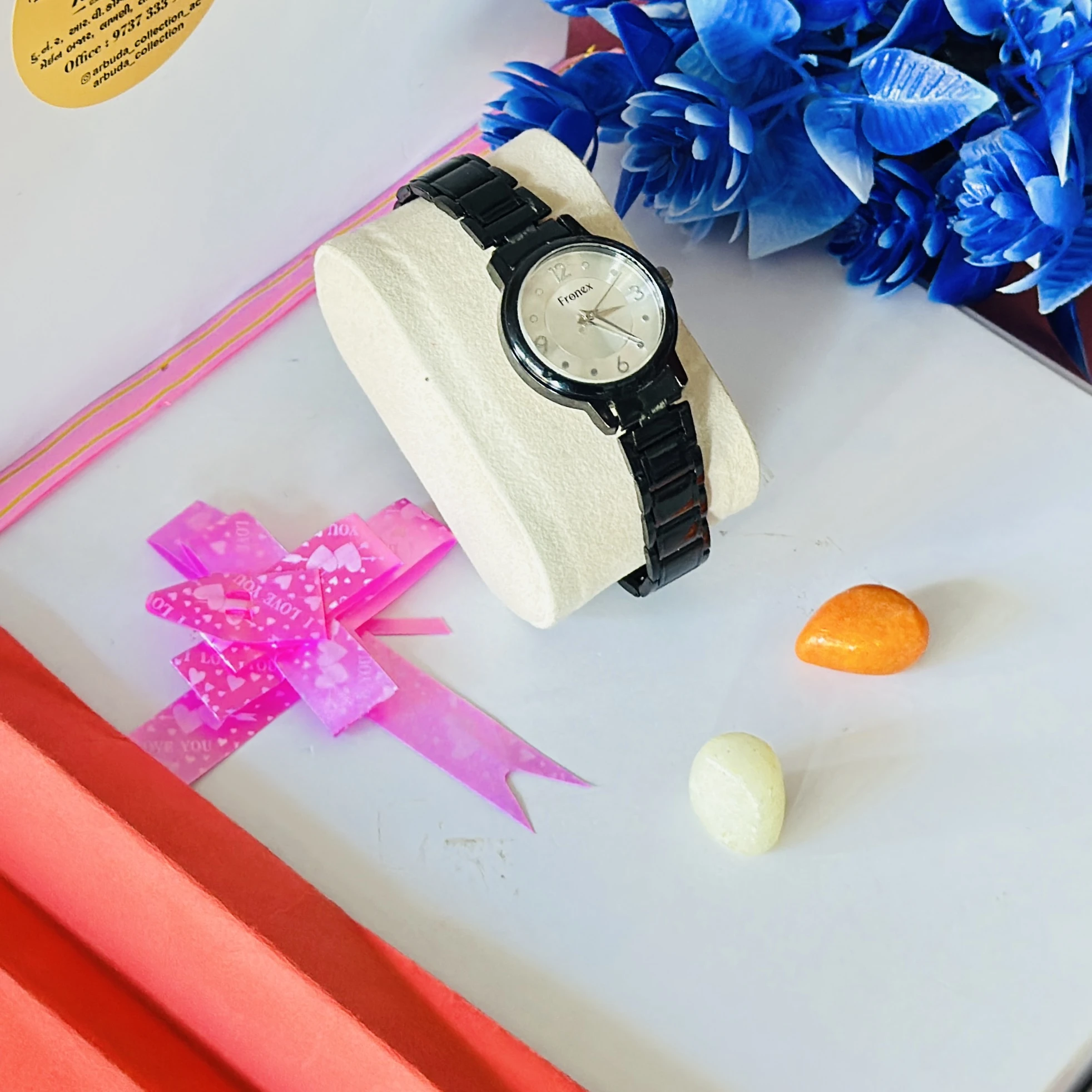 appears to be a black analog wristwatch for women