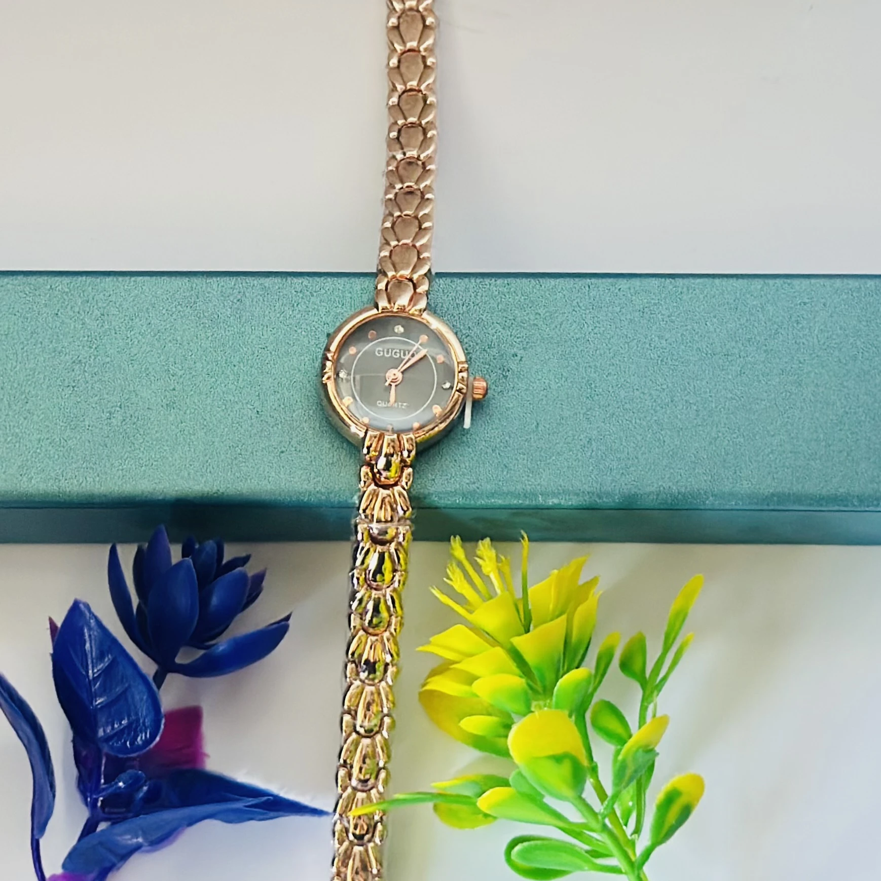 analog women's watch with a rose gold-toned metal strap.