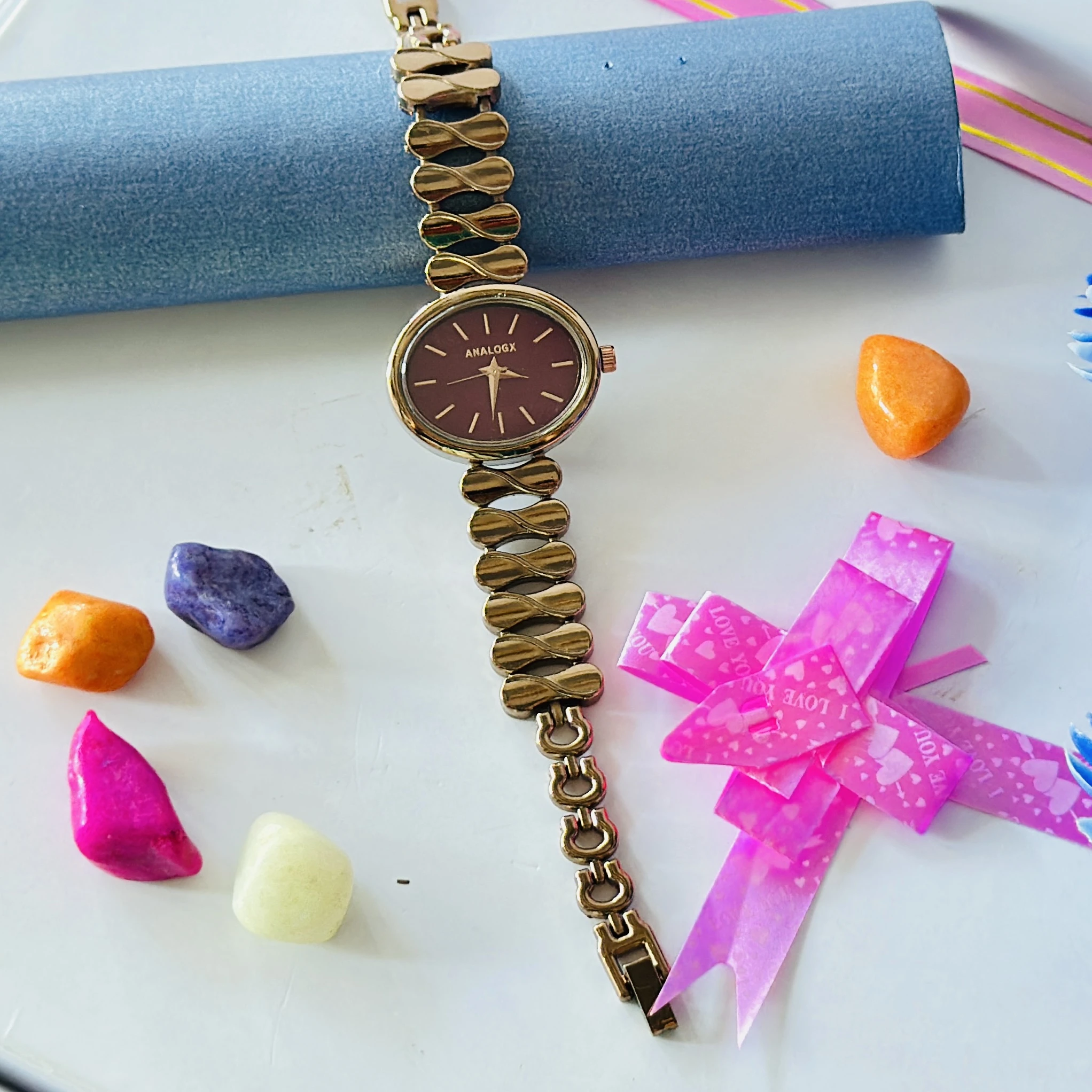 gold-tone Analogx brand women's analog wristwatch with a unique link bracelet.