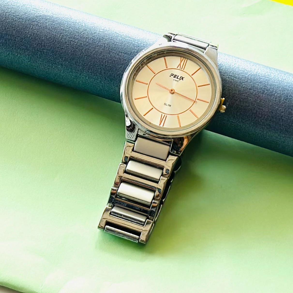 Felix Time slim stainless steel analog watch.
