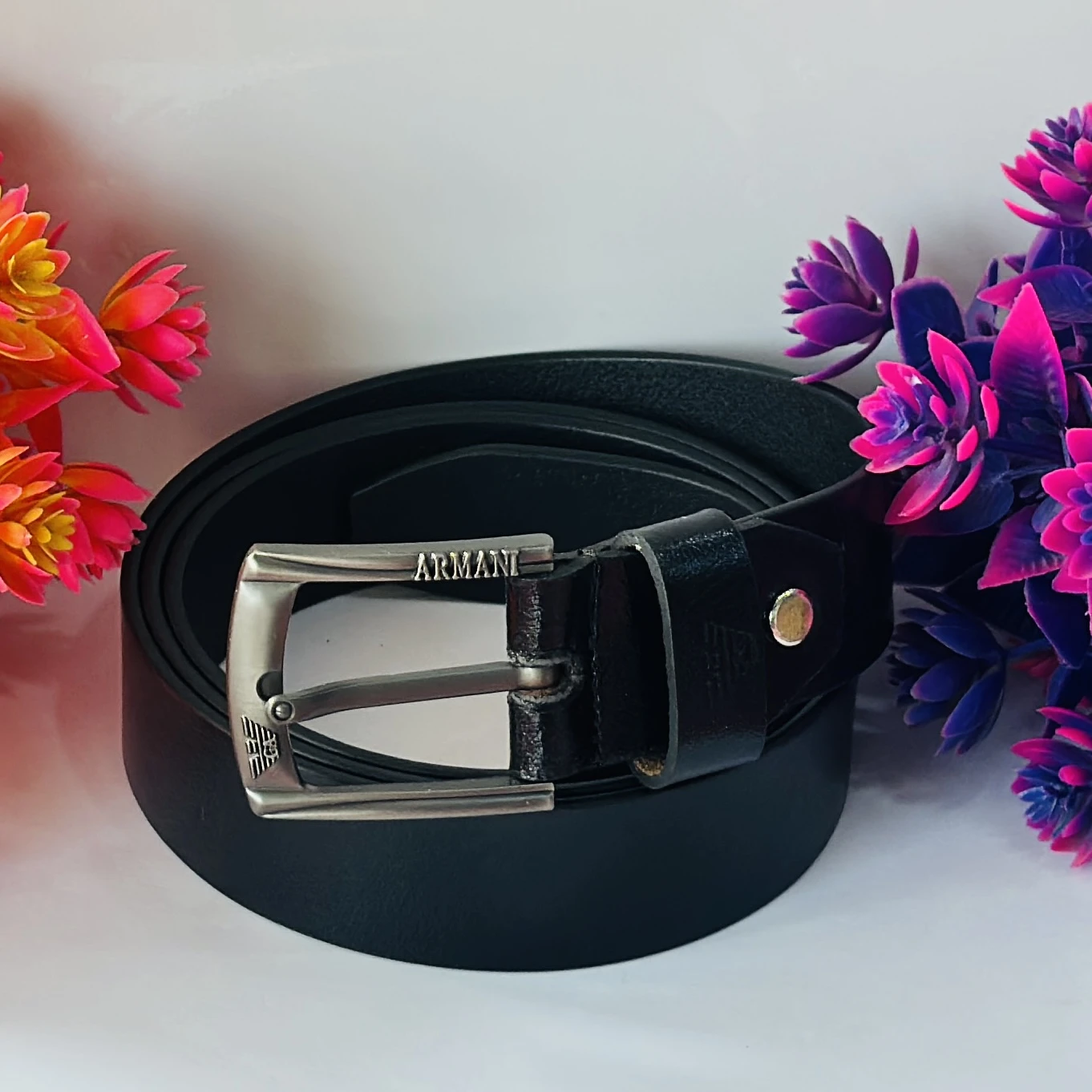 Black leather belt with a gunmetal buckle.