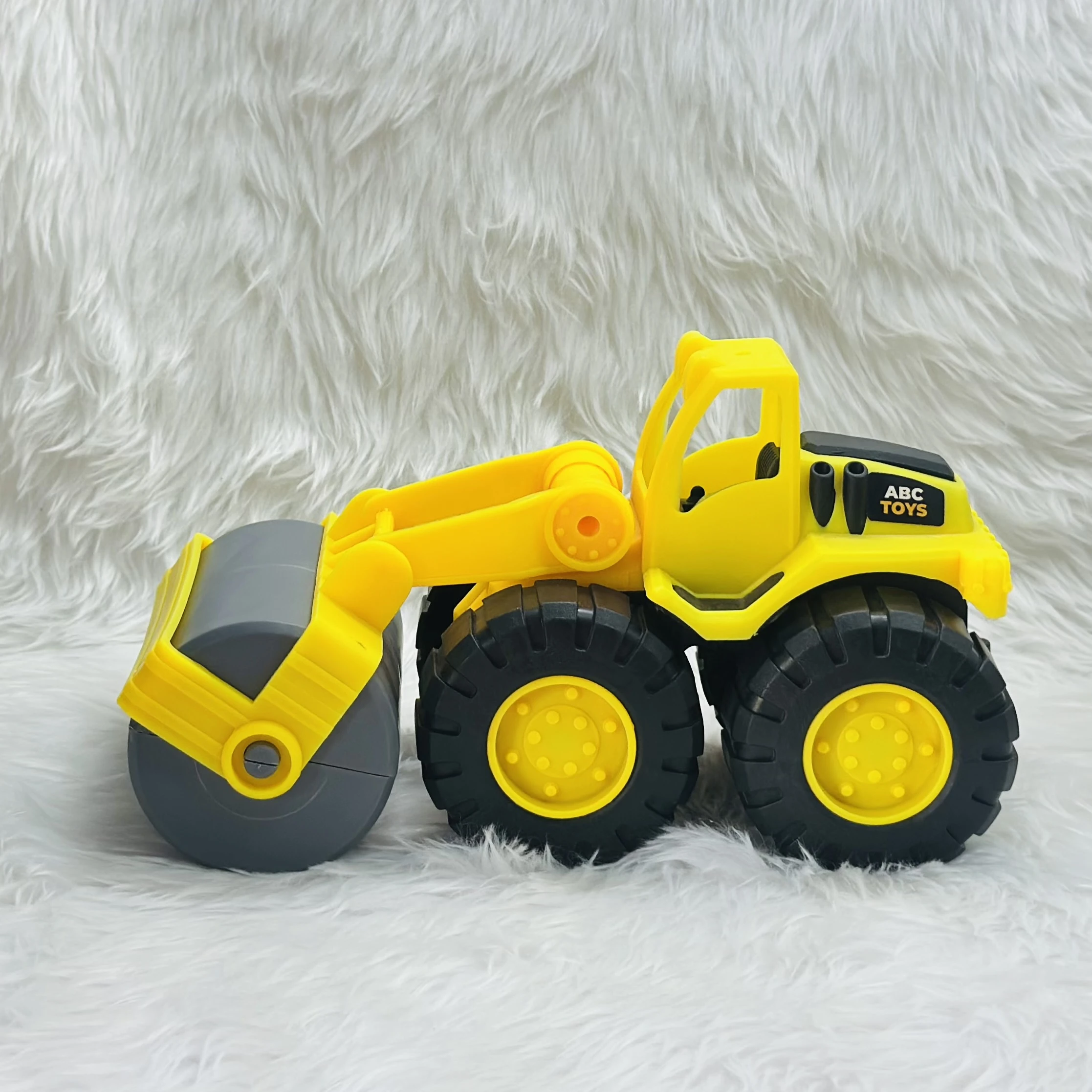 Yellow ABC Toys plastic road roller toy.