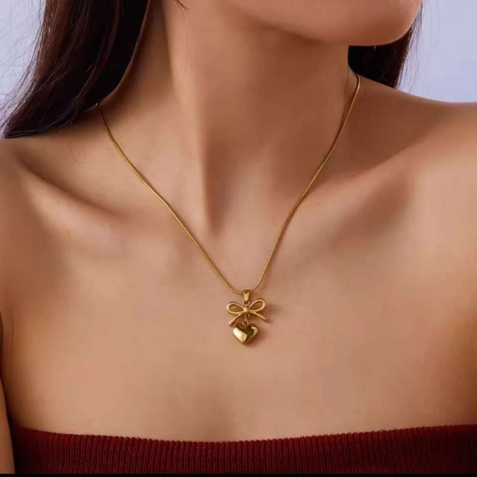 Lumora Forever Gleaming necklace features a heart and bow pendant