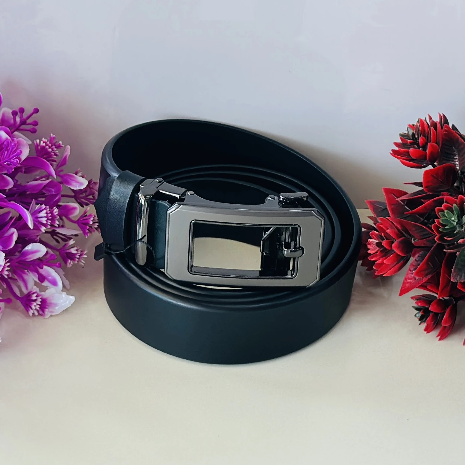 Black leather auto-lock or ratchet buckle belt for men.