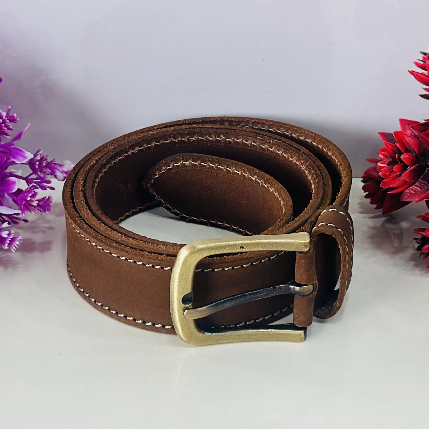 Brown genuine leather belt with a pin buckle closure.
